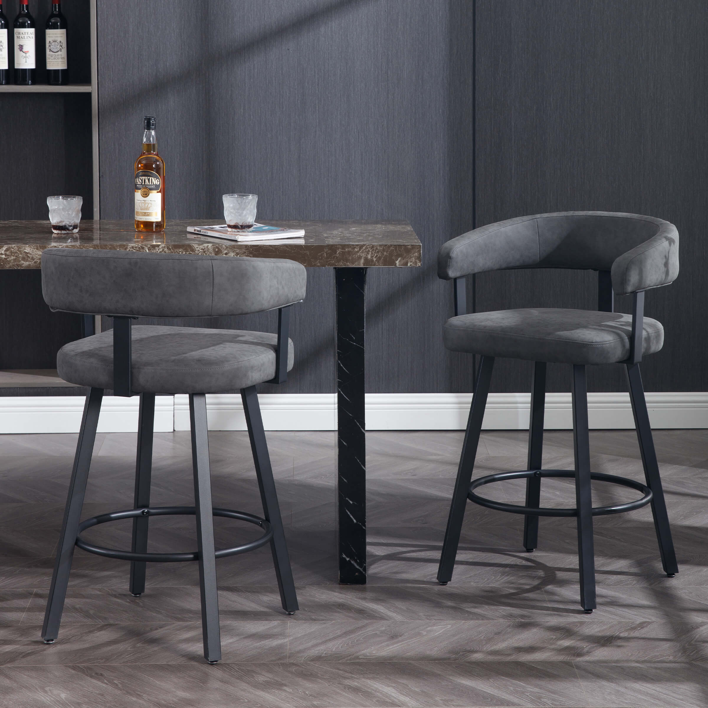 Two gray bar stools around dark modern kitchen