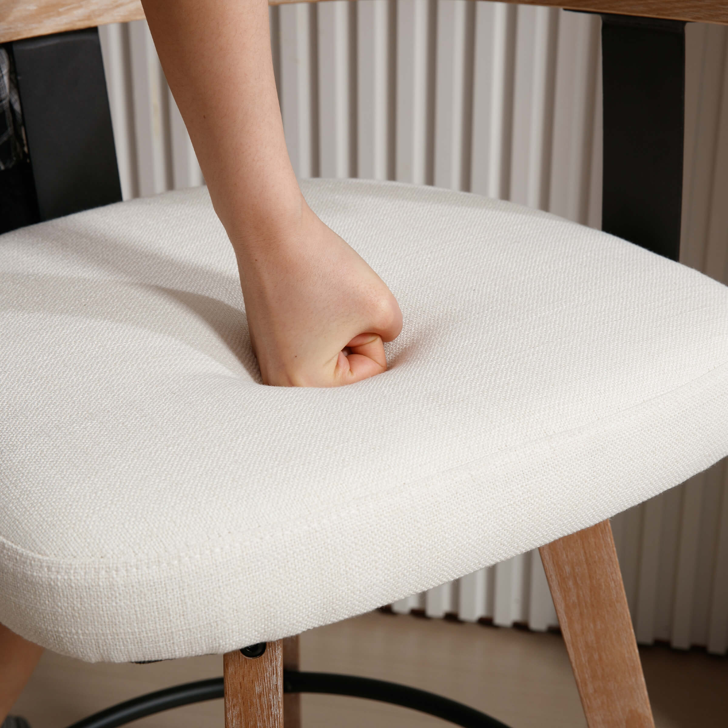 Hands pressing cushion