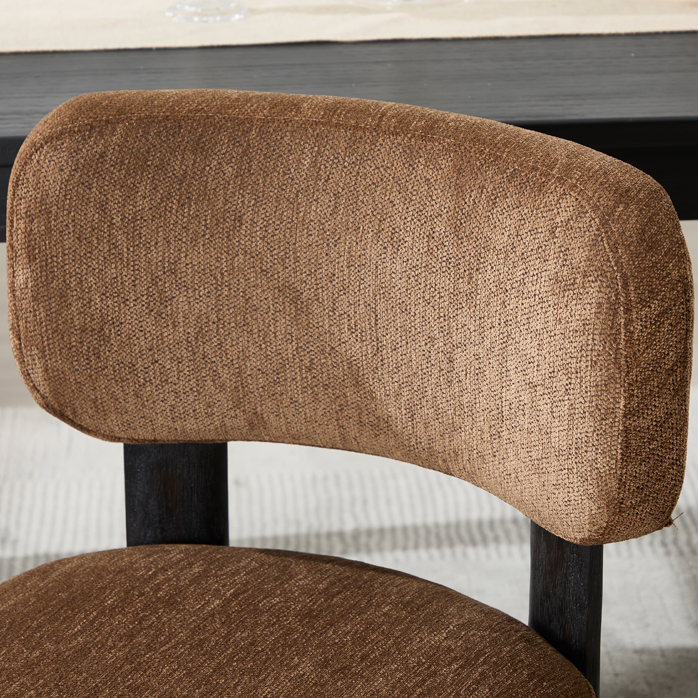 Brown upholstered curved backrest chair