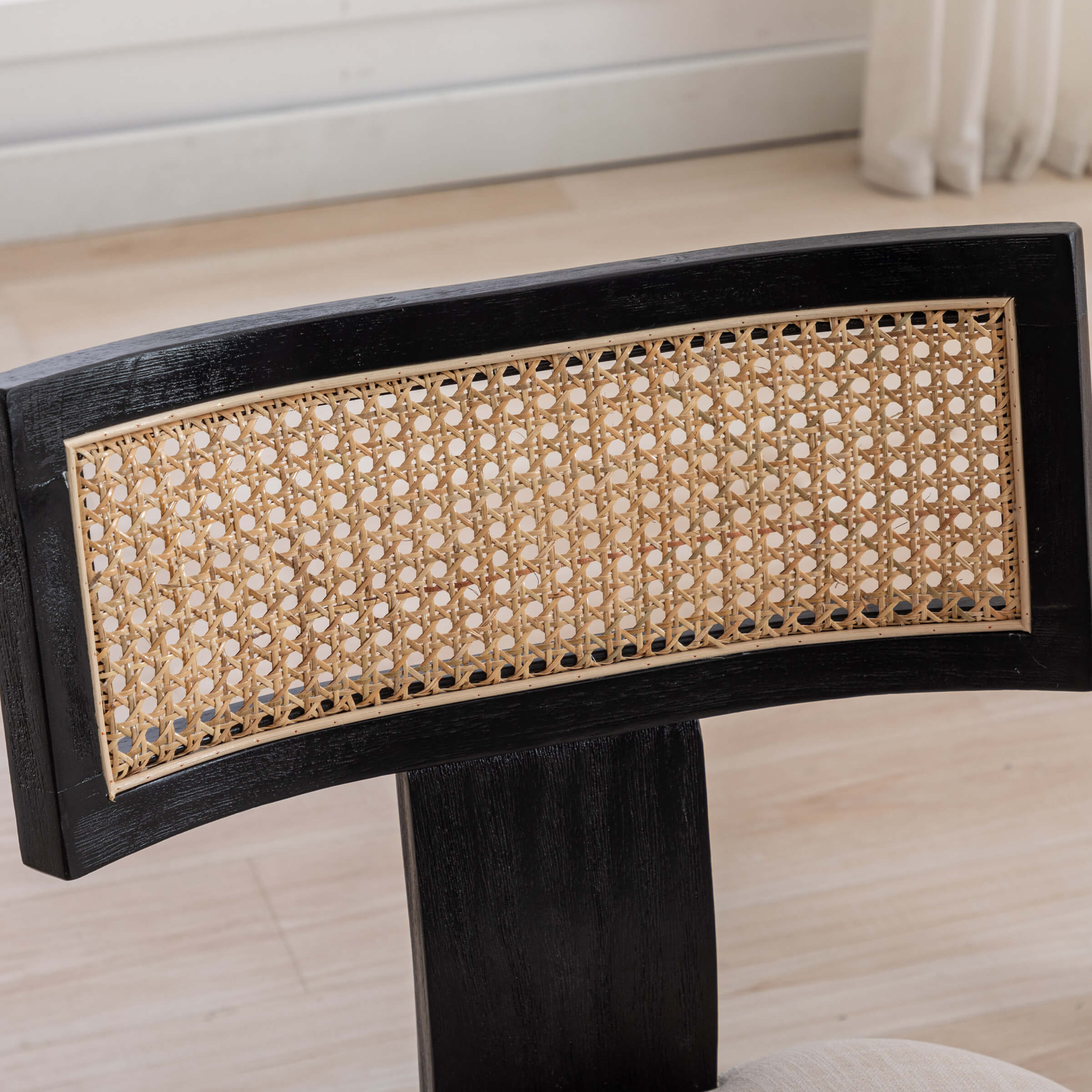 Close-up of black chair back and rattan weave