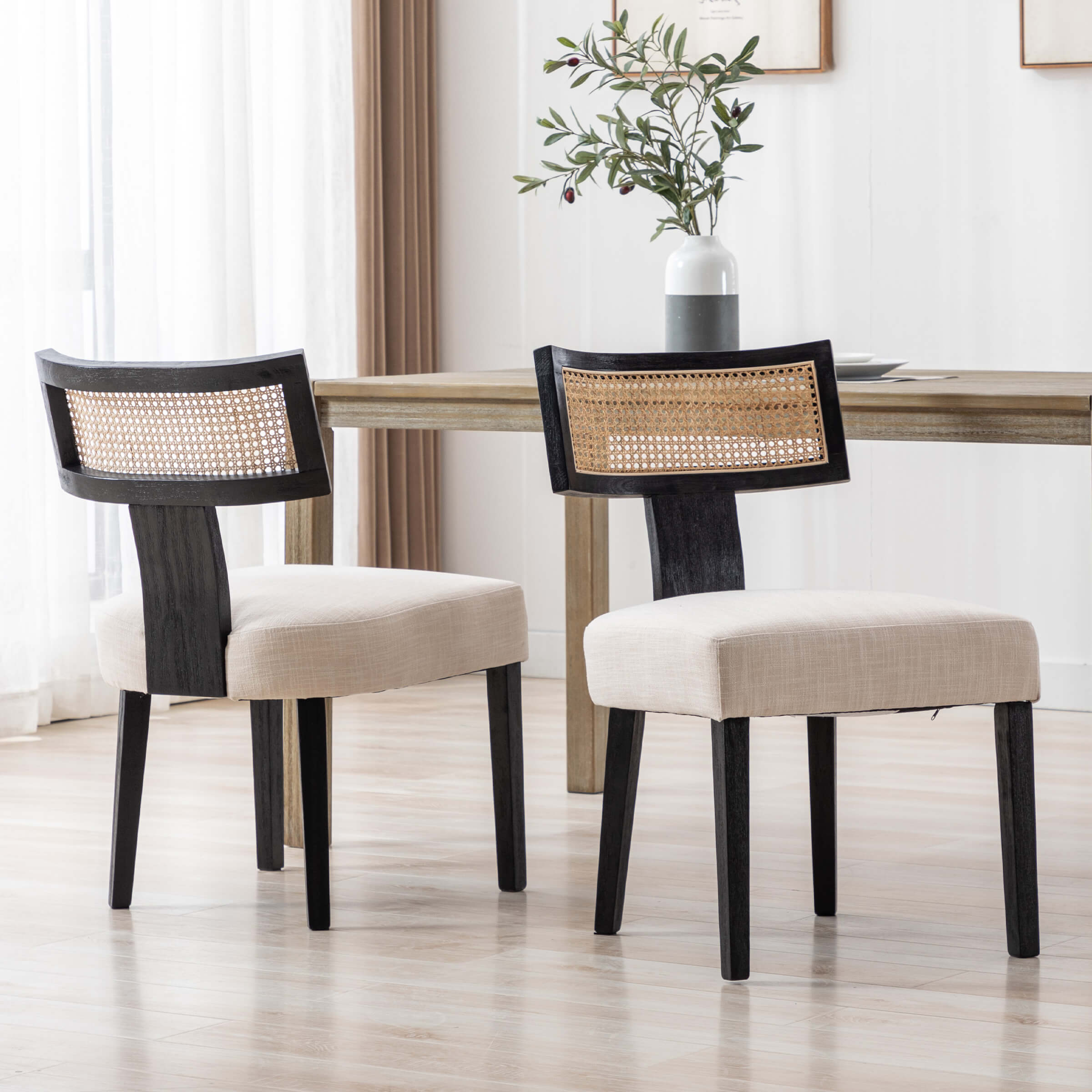 Two chairs with white vase on table