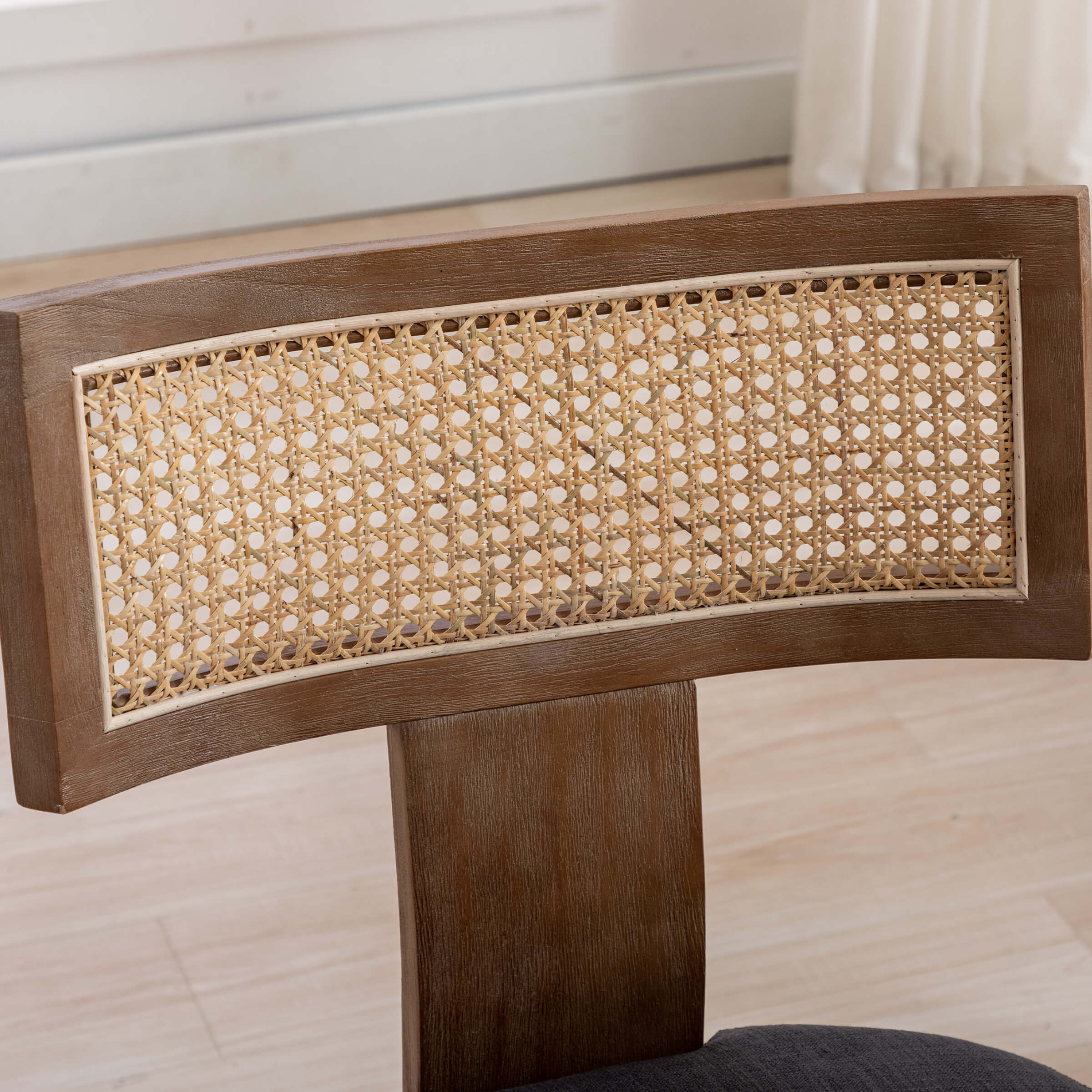 Two chairs with beige upholstery and cane back