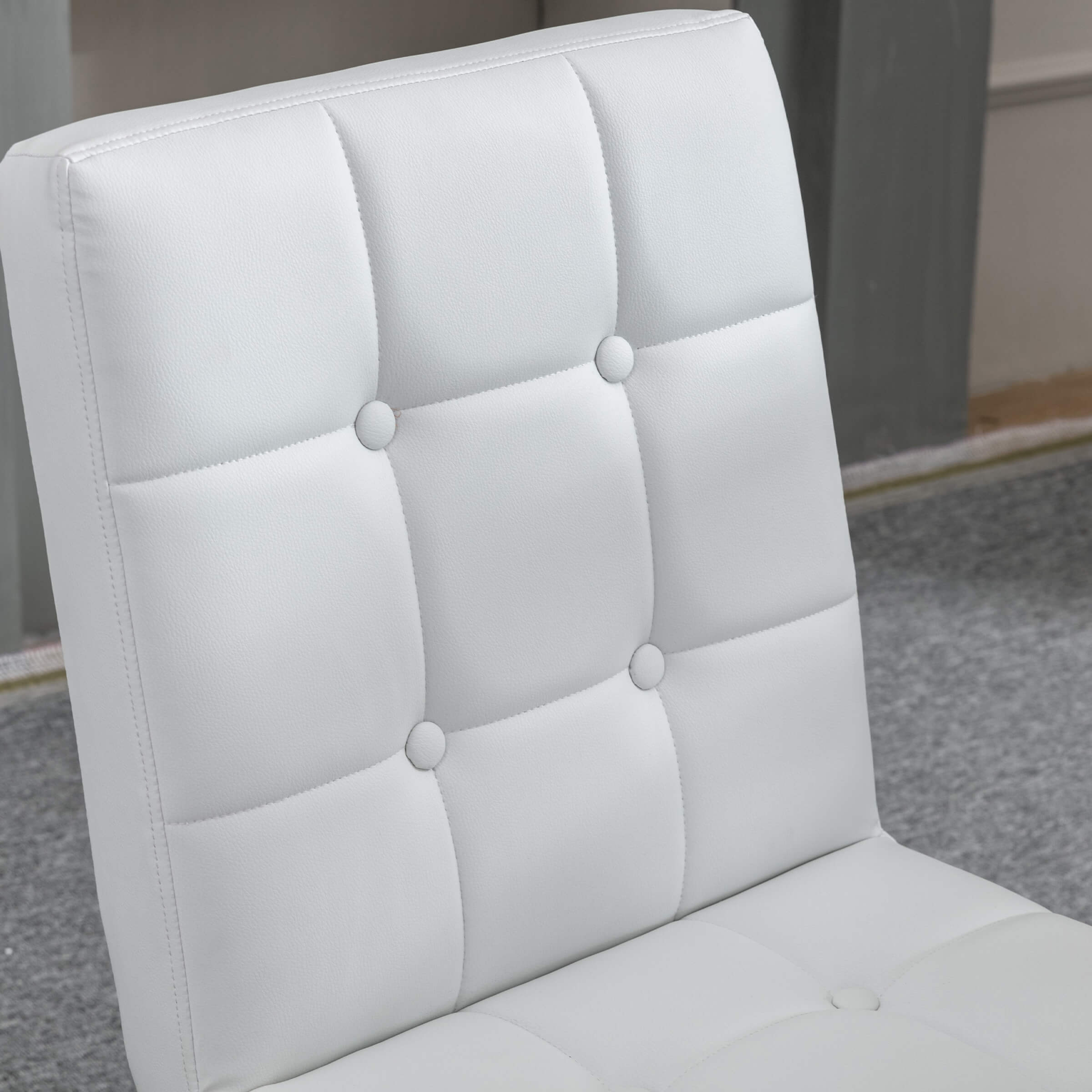 Tufted white leather cushion with buttons