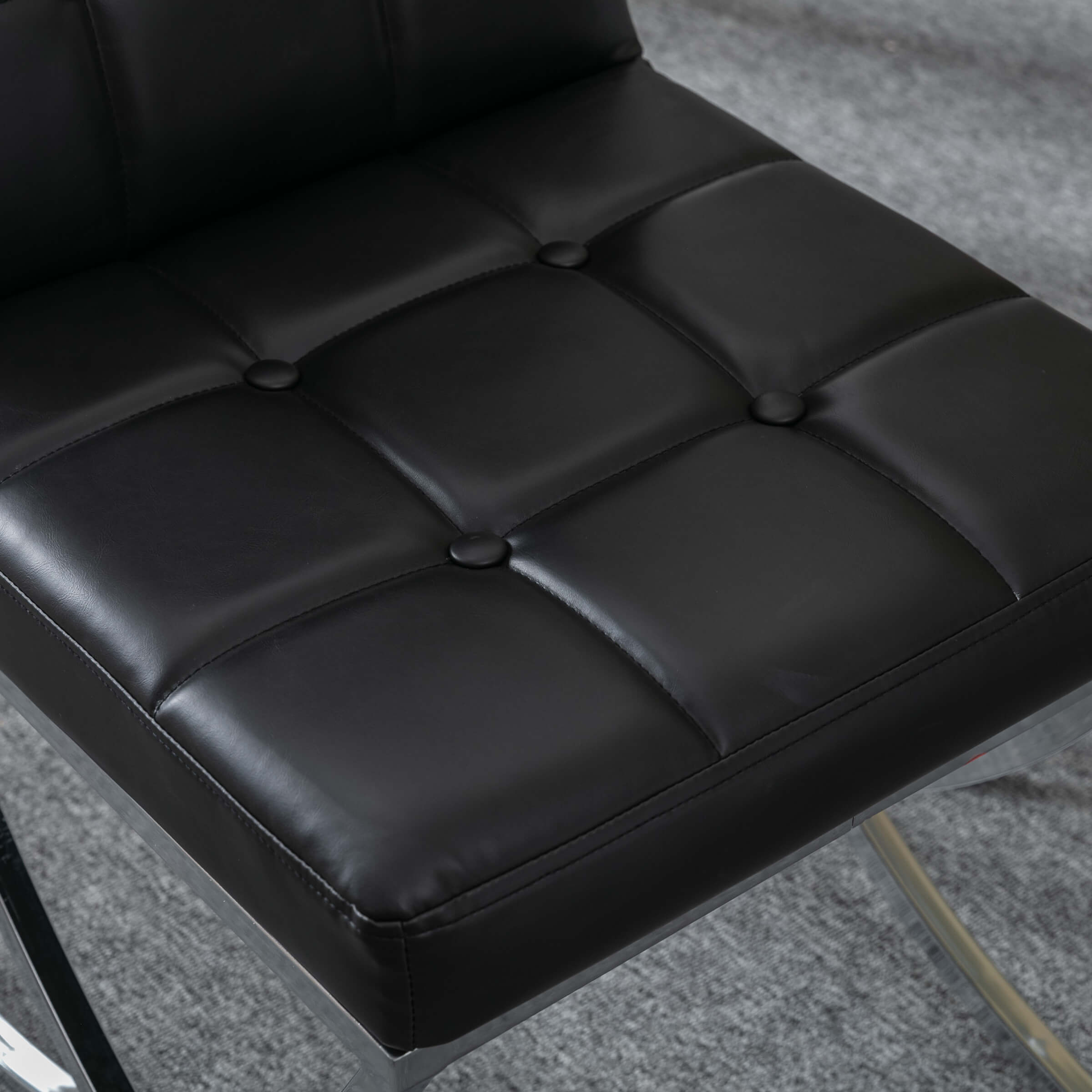 Close-up of tufted seat surface with buttons