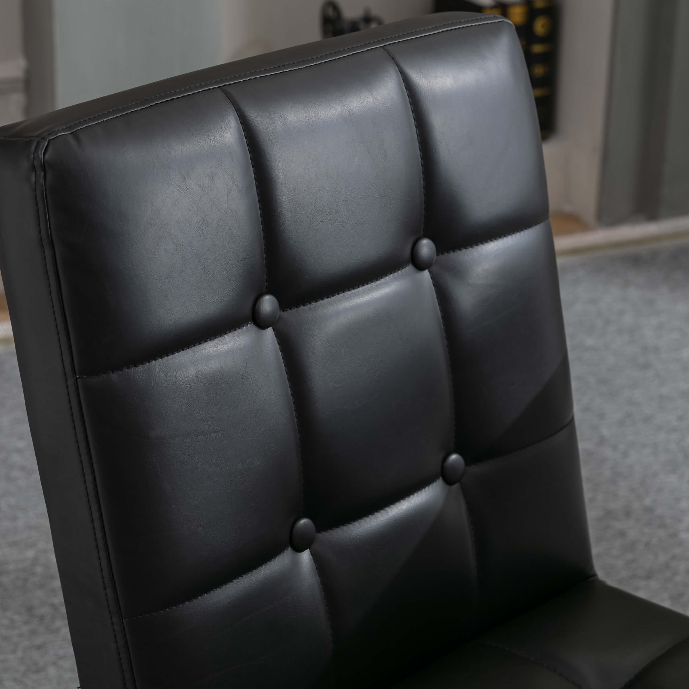 Leather tufted chair back button close-up