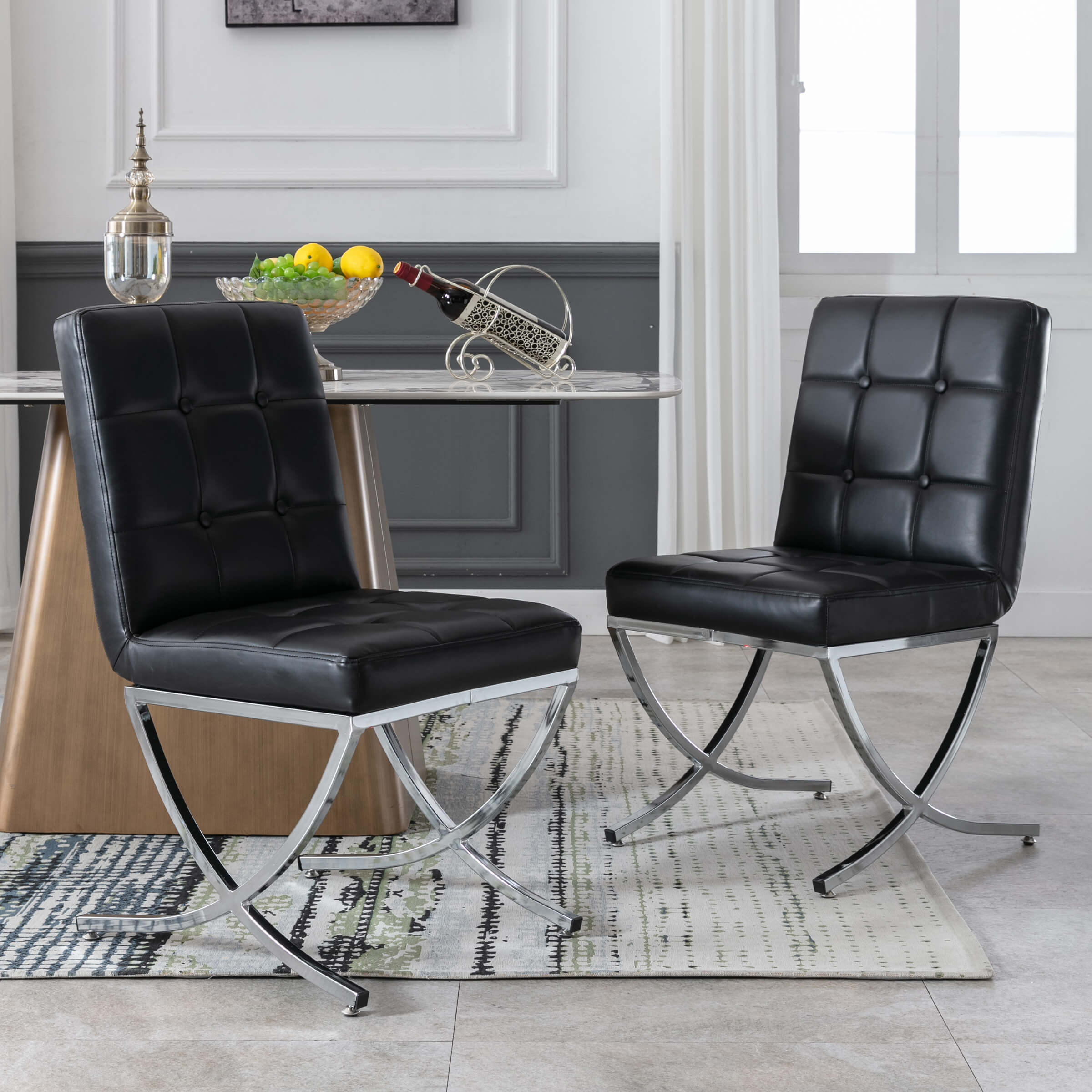 Two black tufted chairs around table in kitchen