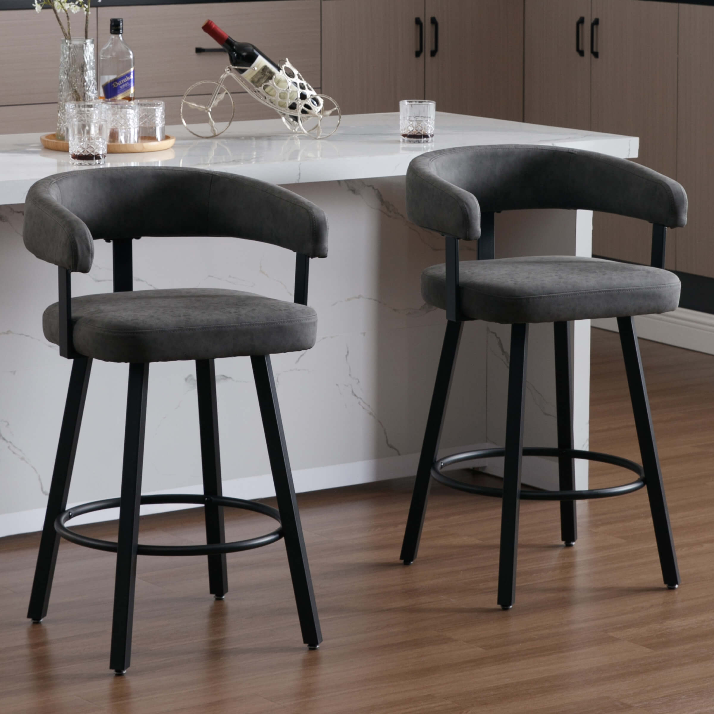 Two bar stools with gray upholstery around kitchen island