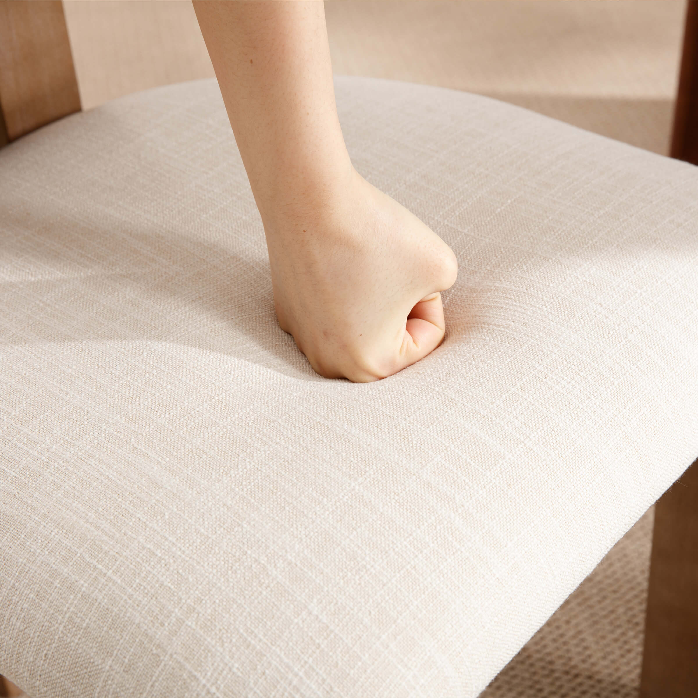 Close-up of seat cushion being pressed