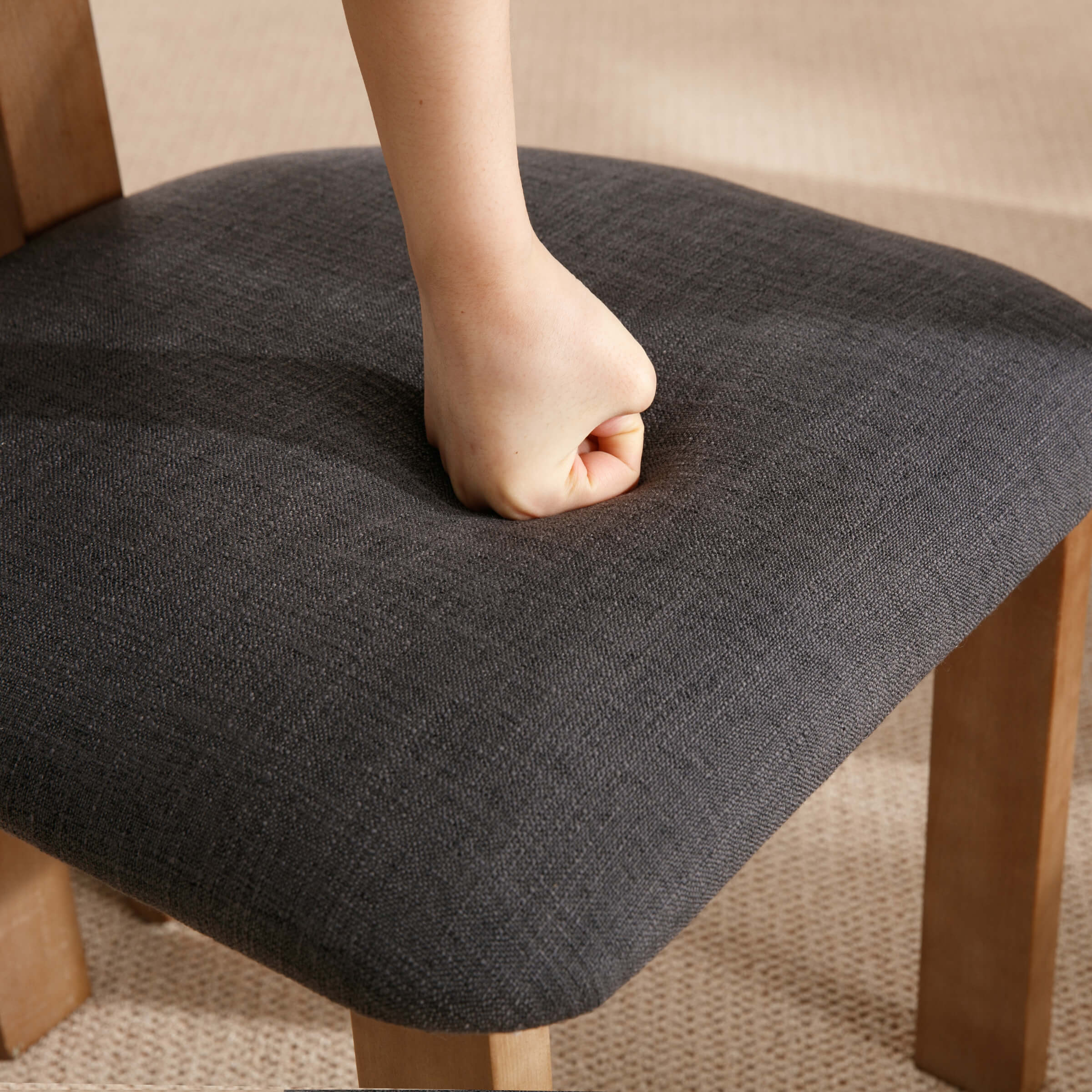 Close-up of seat cushion with hand press