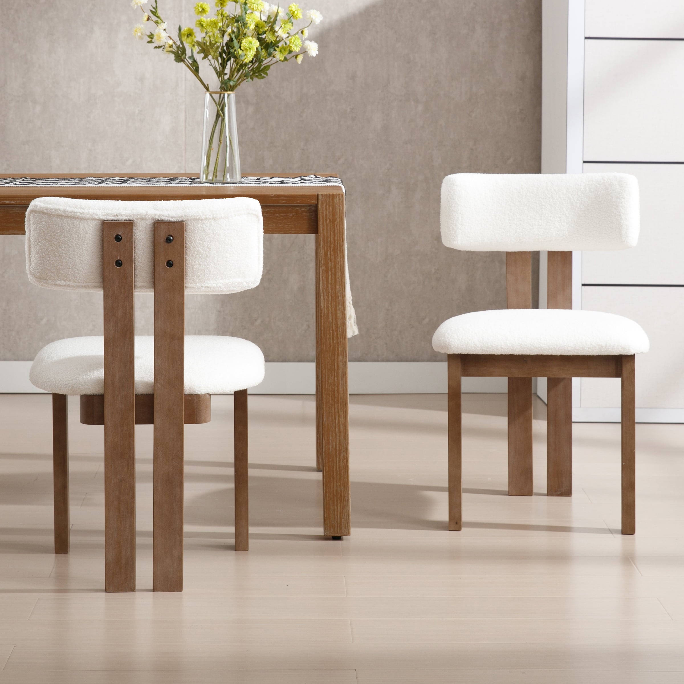 Cream chairs around table with vase