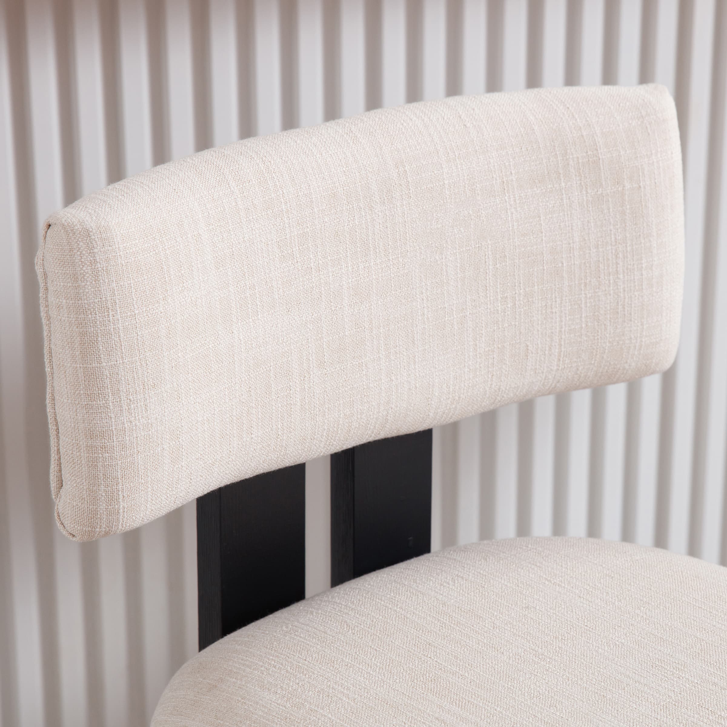 Beige cushion close-up on black frame