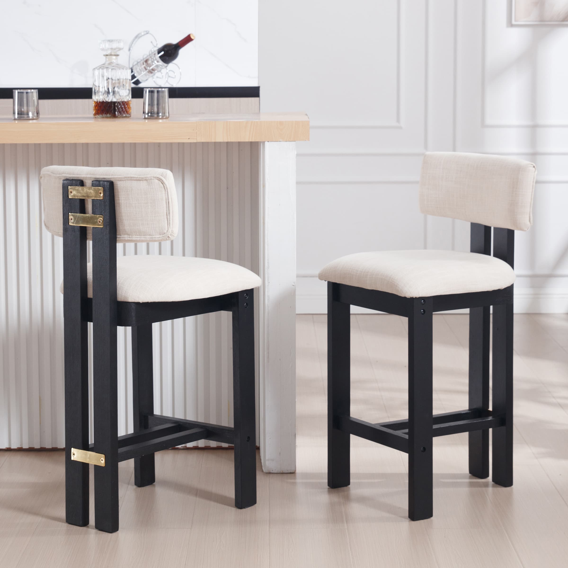 Two stools with black frame and beige cushions