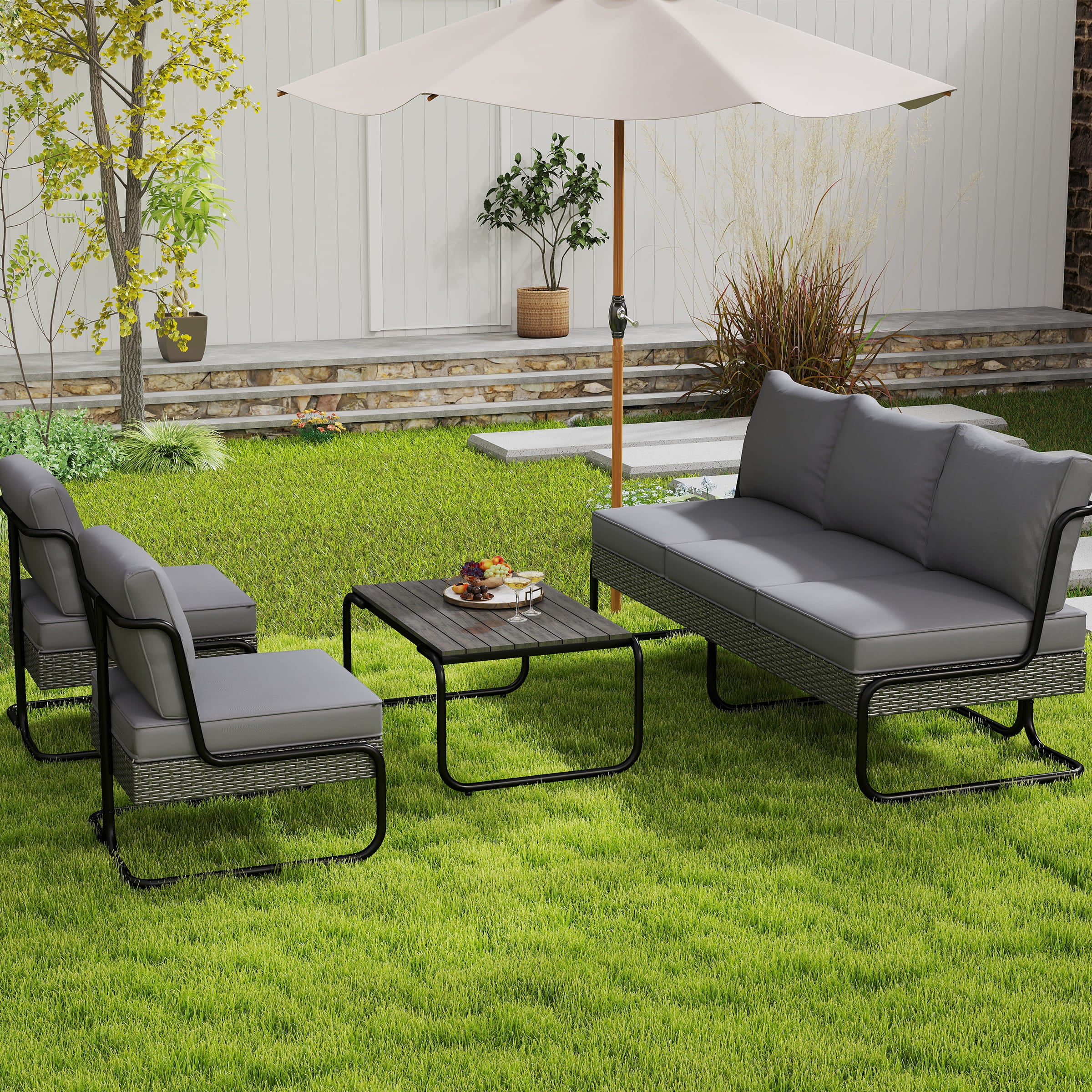 Grey outdoor furniture set with umbrella on lawn