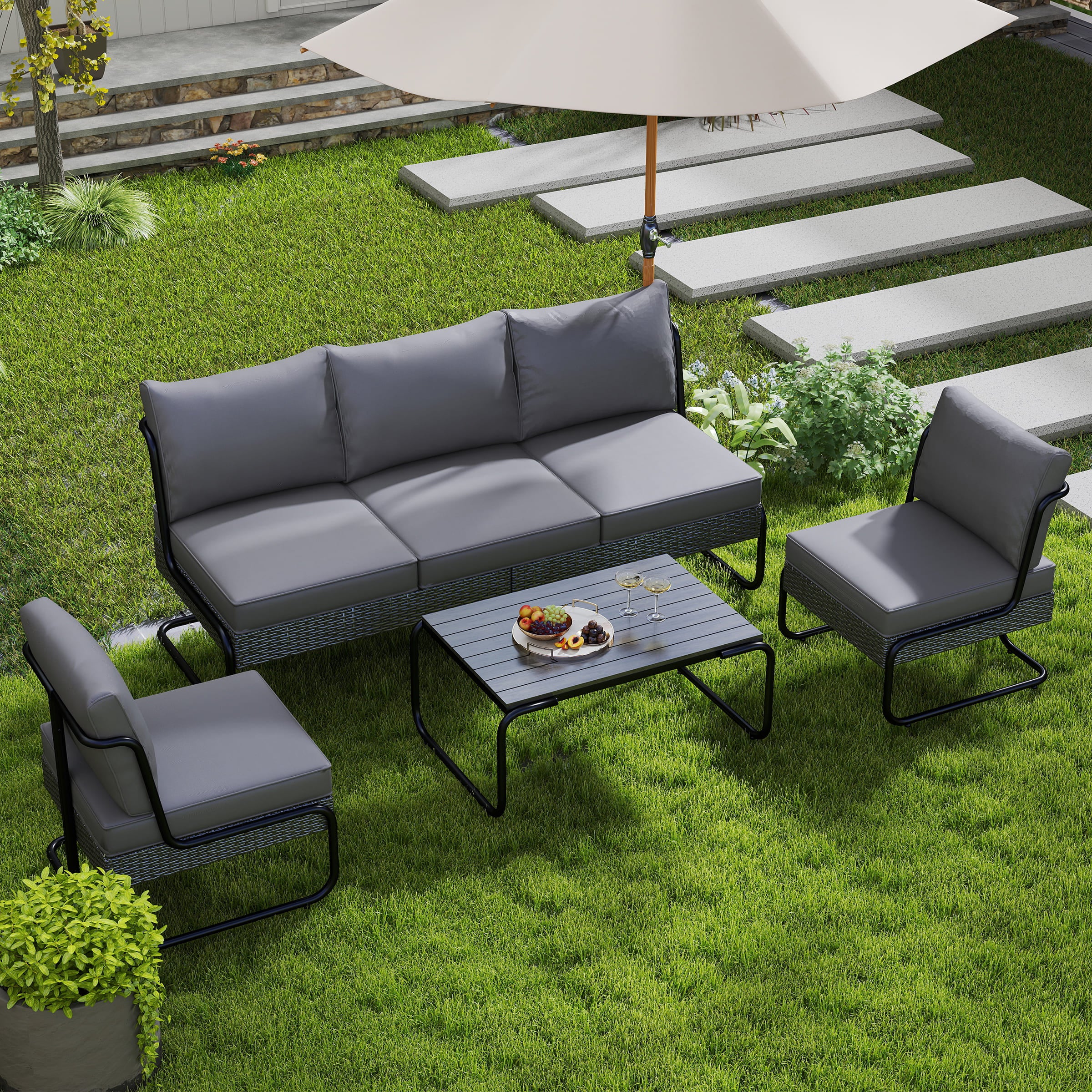 Grey outdoor furniture set on lawn with umbrella