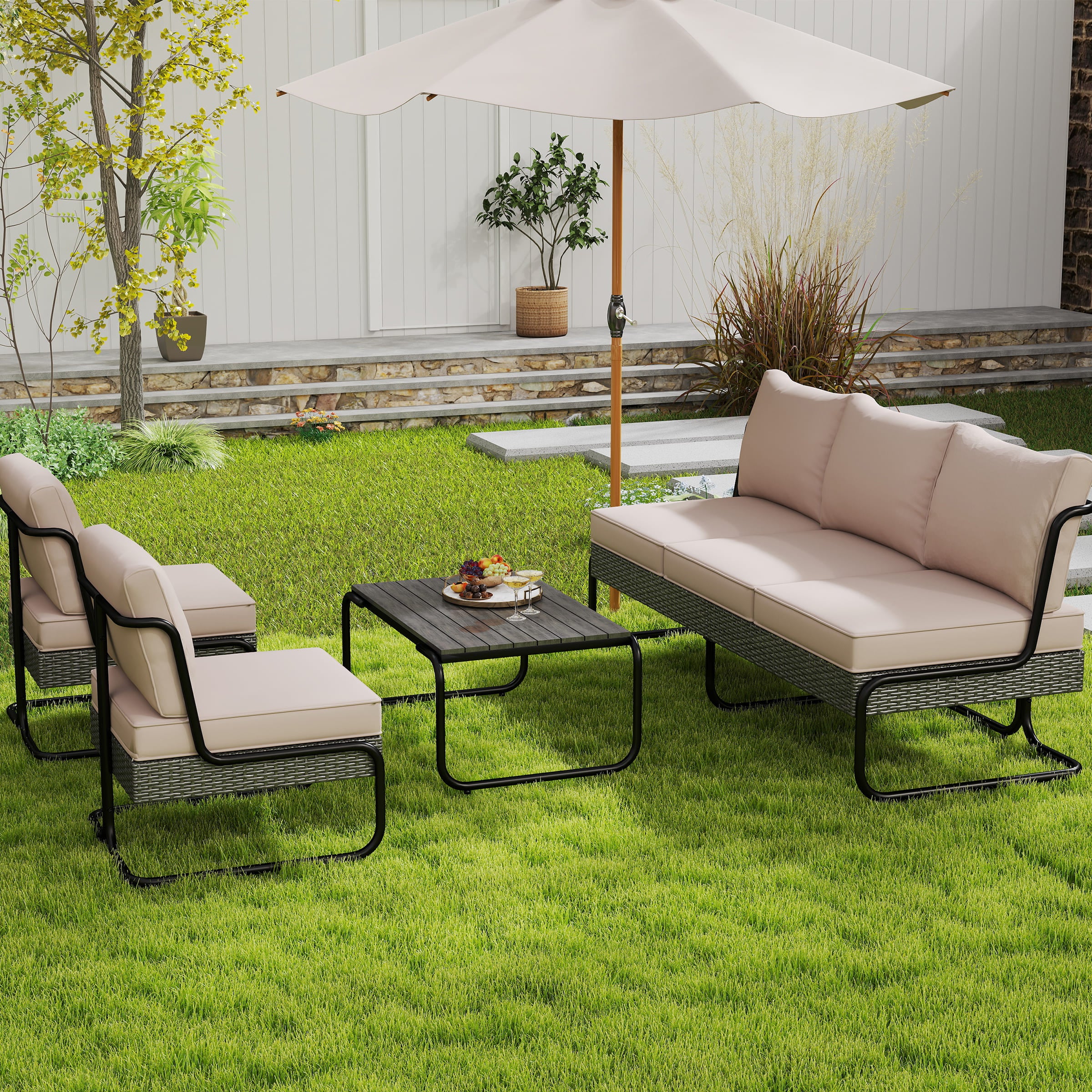 Outdoor beige cushioned patio furniture set on grass with umbrella