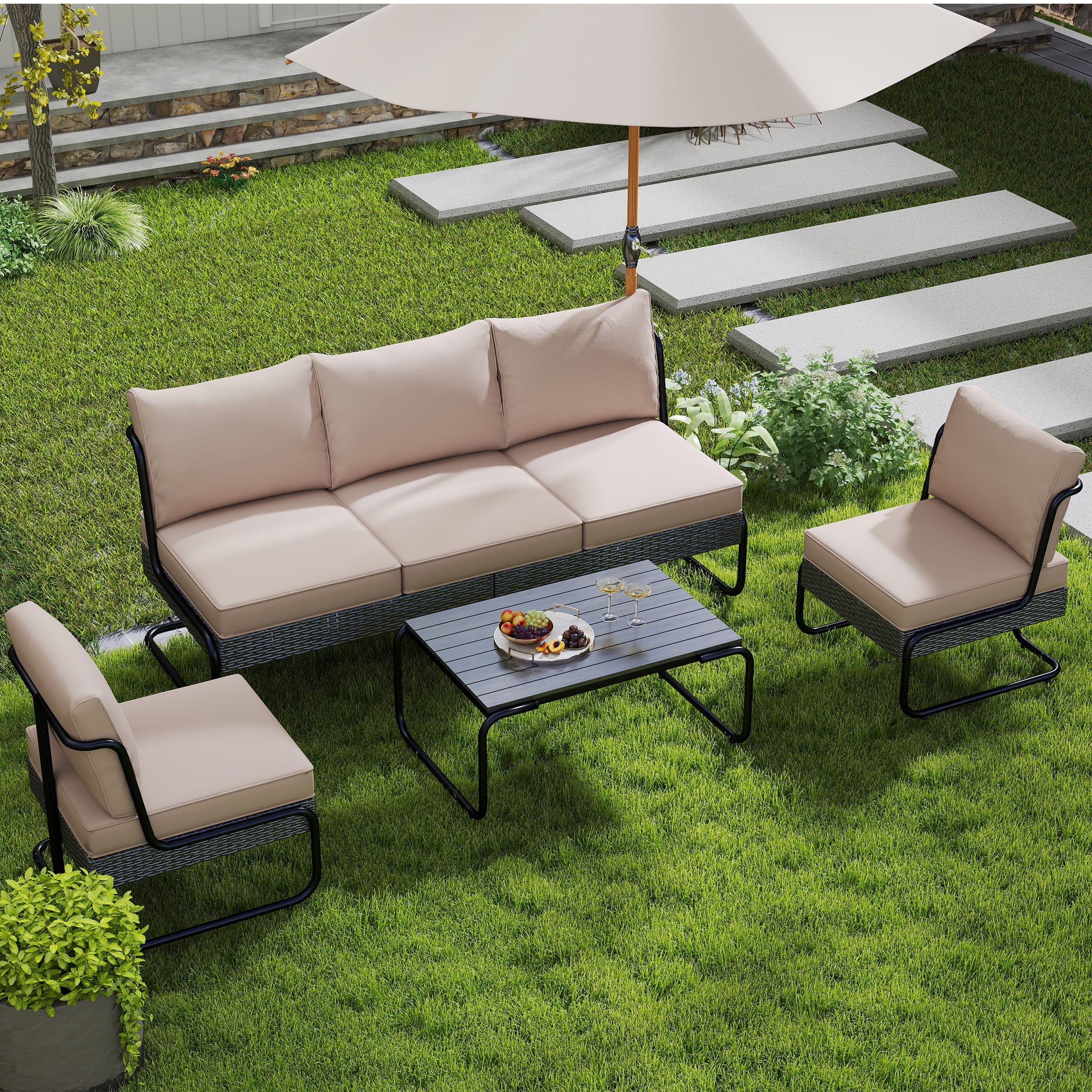 Beige cushioned sofa and chairs with umbrella