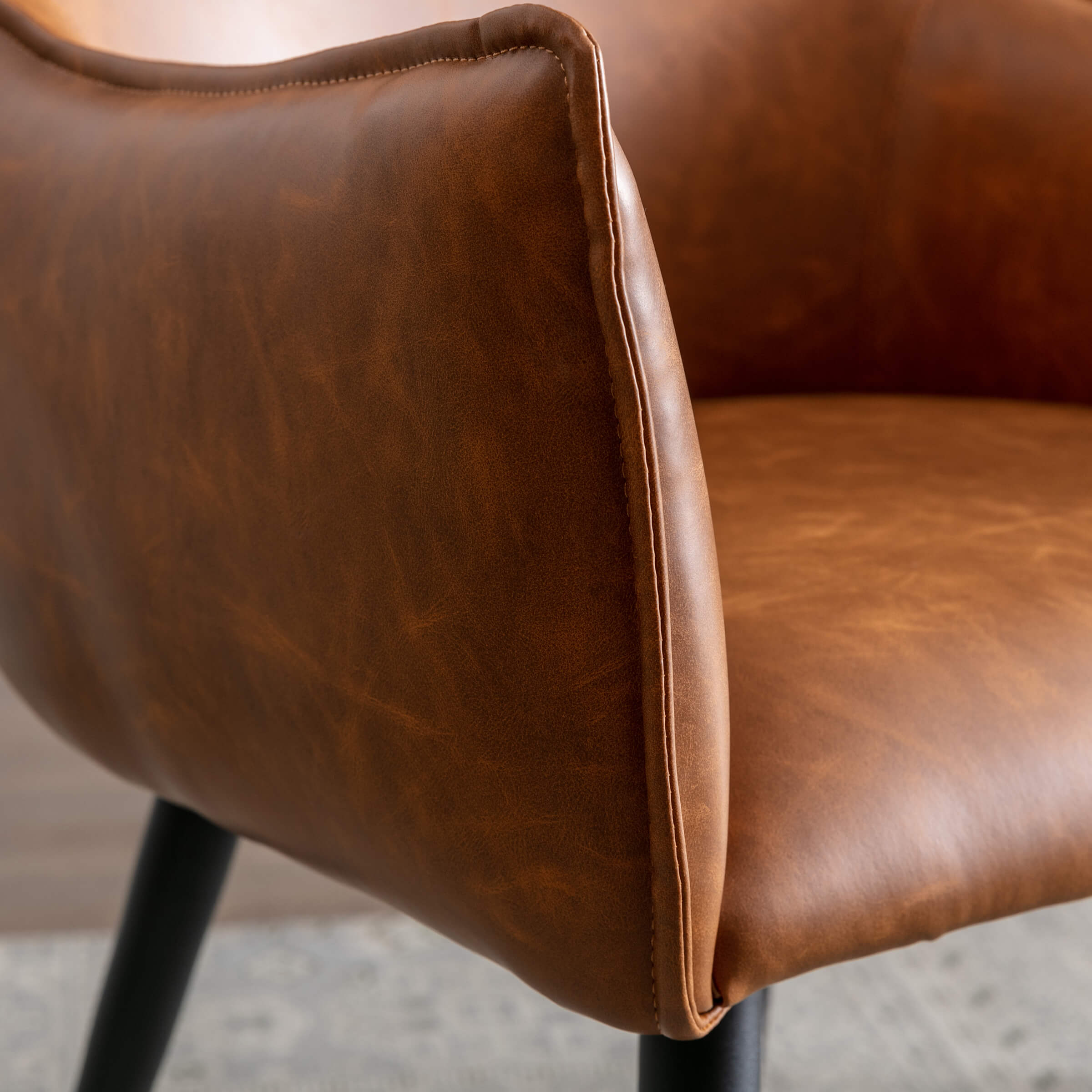 Edge seam and armrest detailing on chair