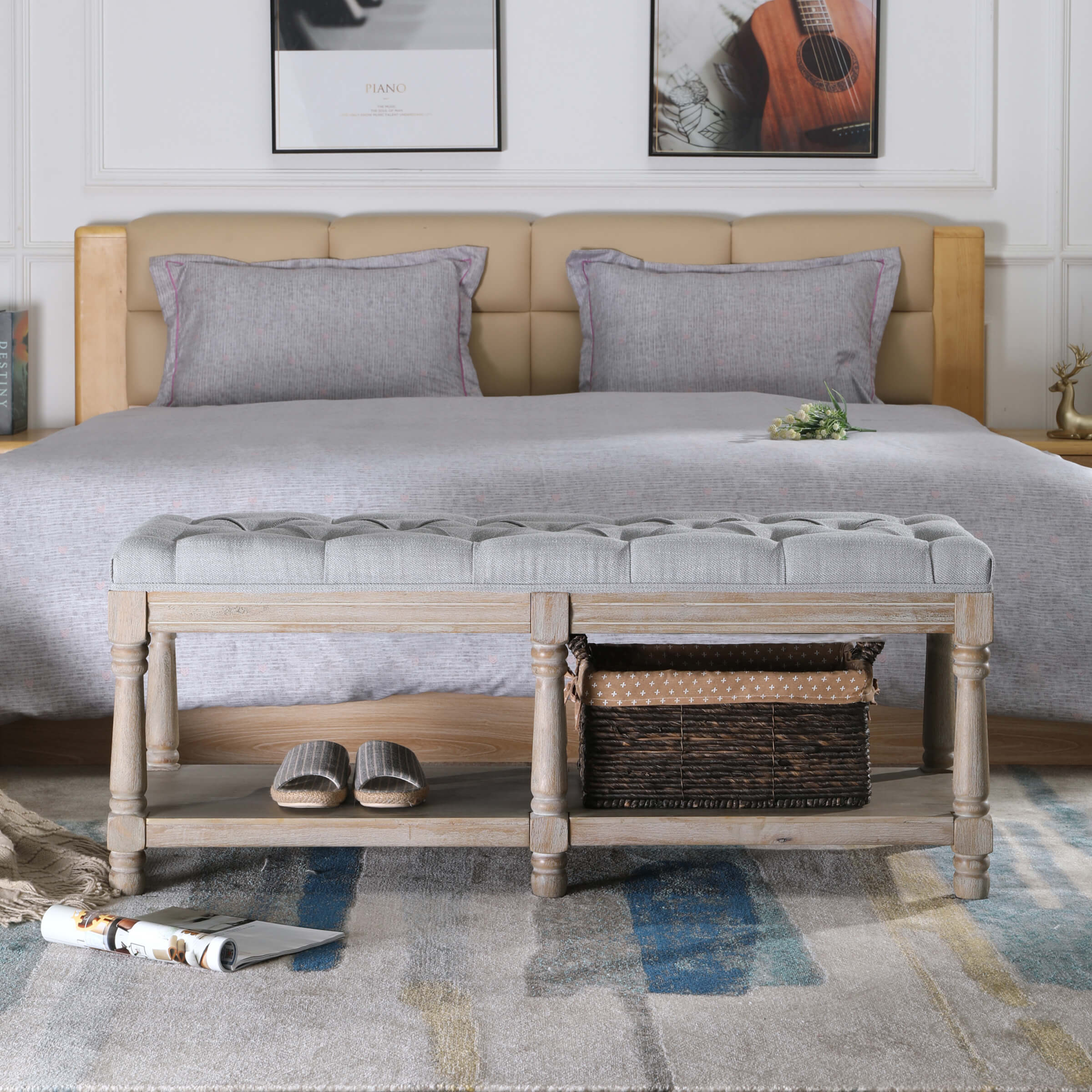 Tufted grey upholstered bench in front of a bed