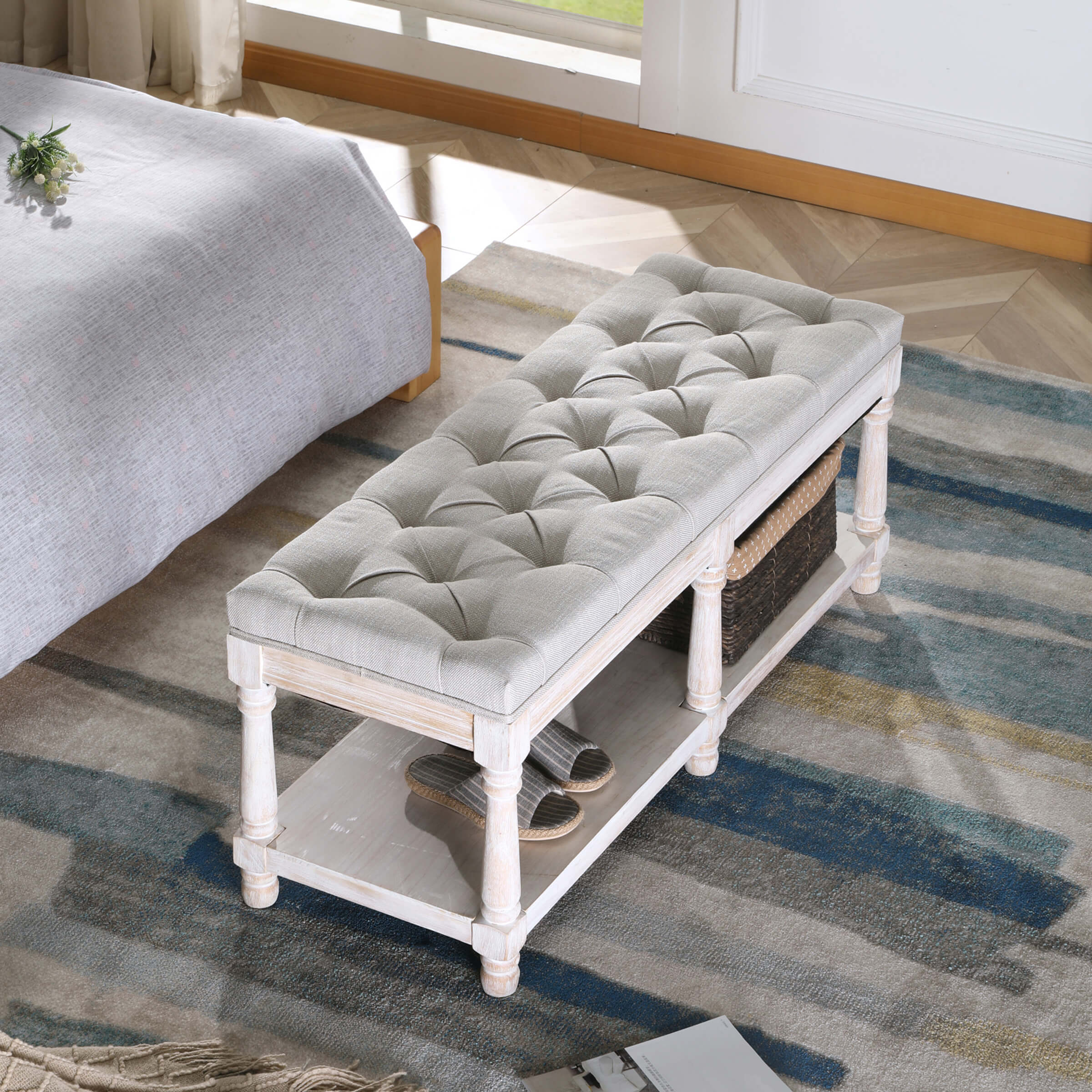 Tufted bench in a bedroom with rug