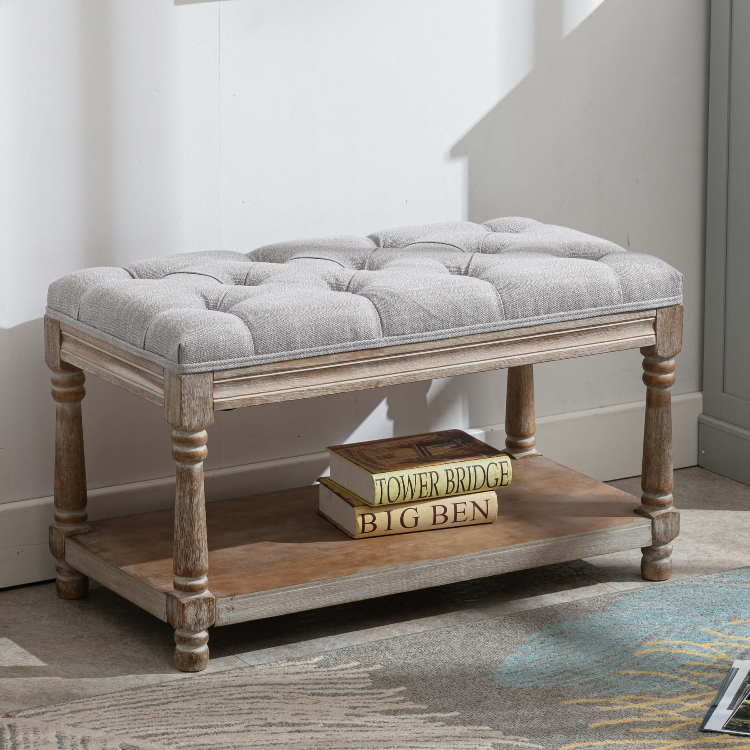 Tufted bench with books under natural light