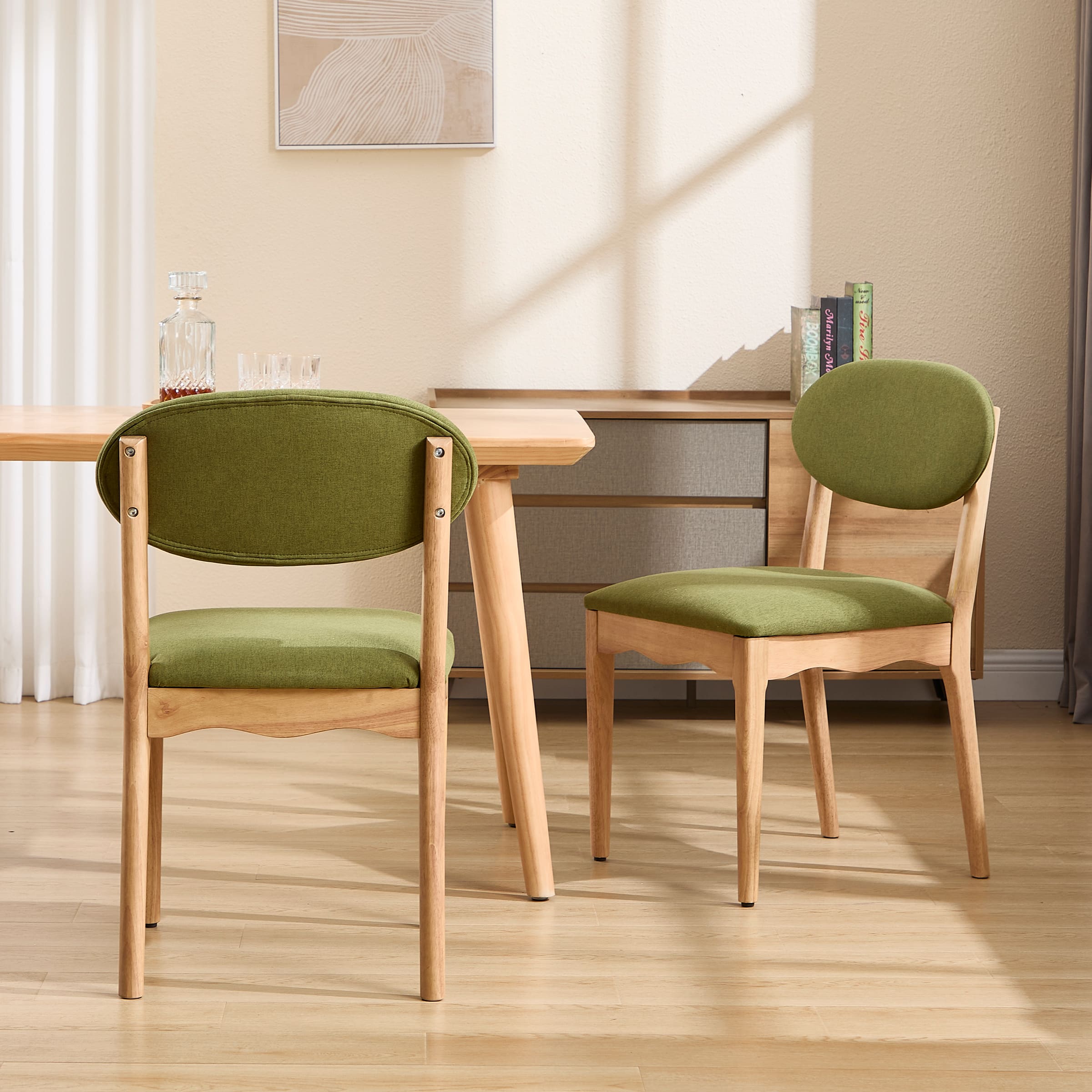 Two green upholstered dining chairs from a different angle