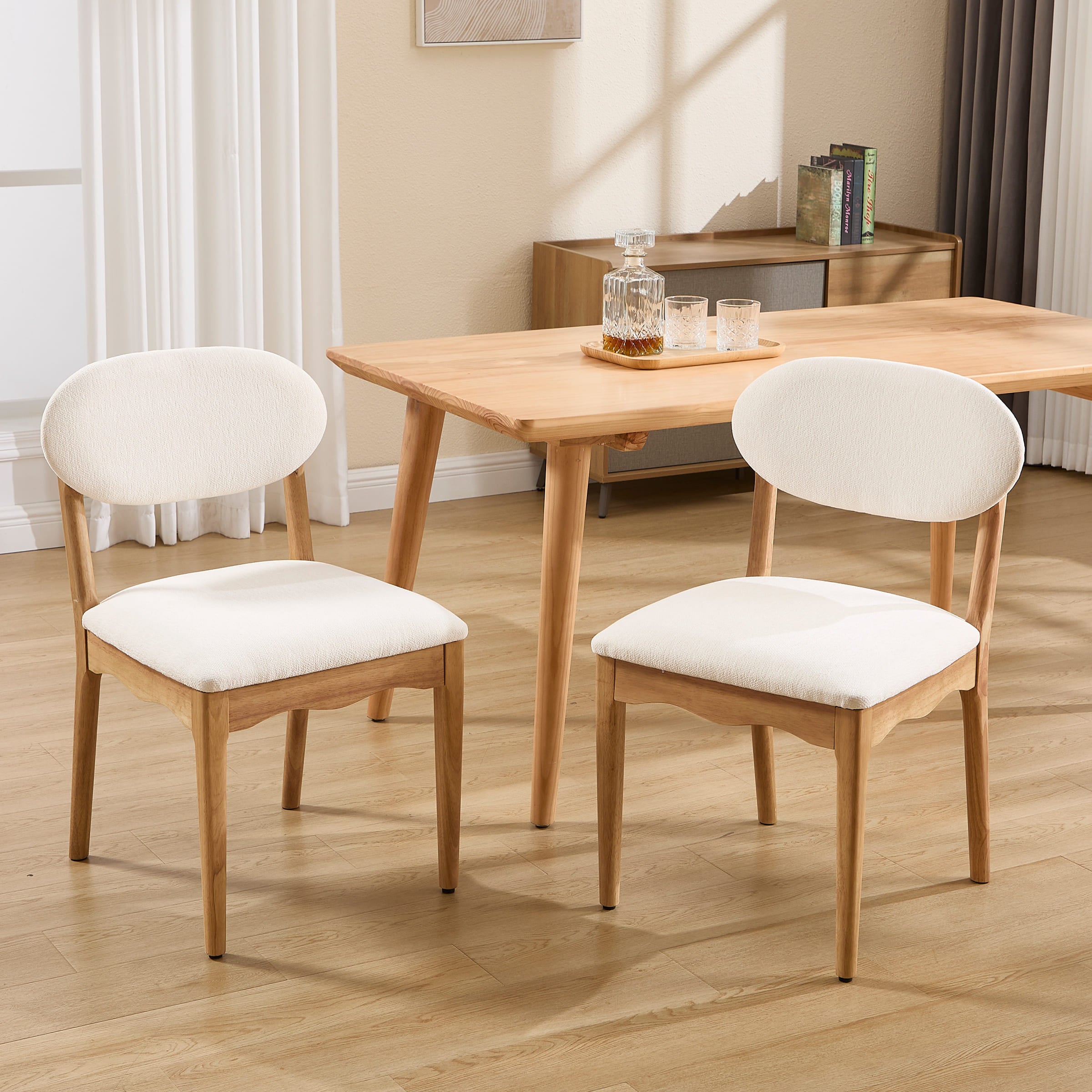 White upholstered dining chairs with wood legs