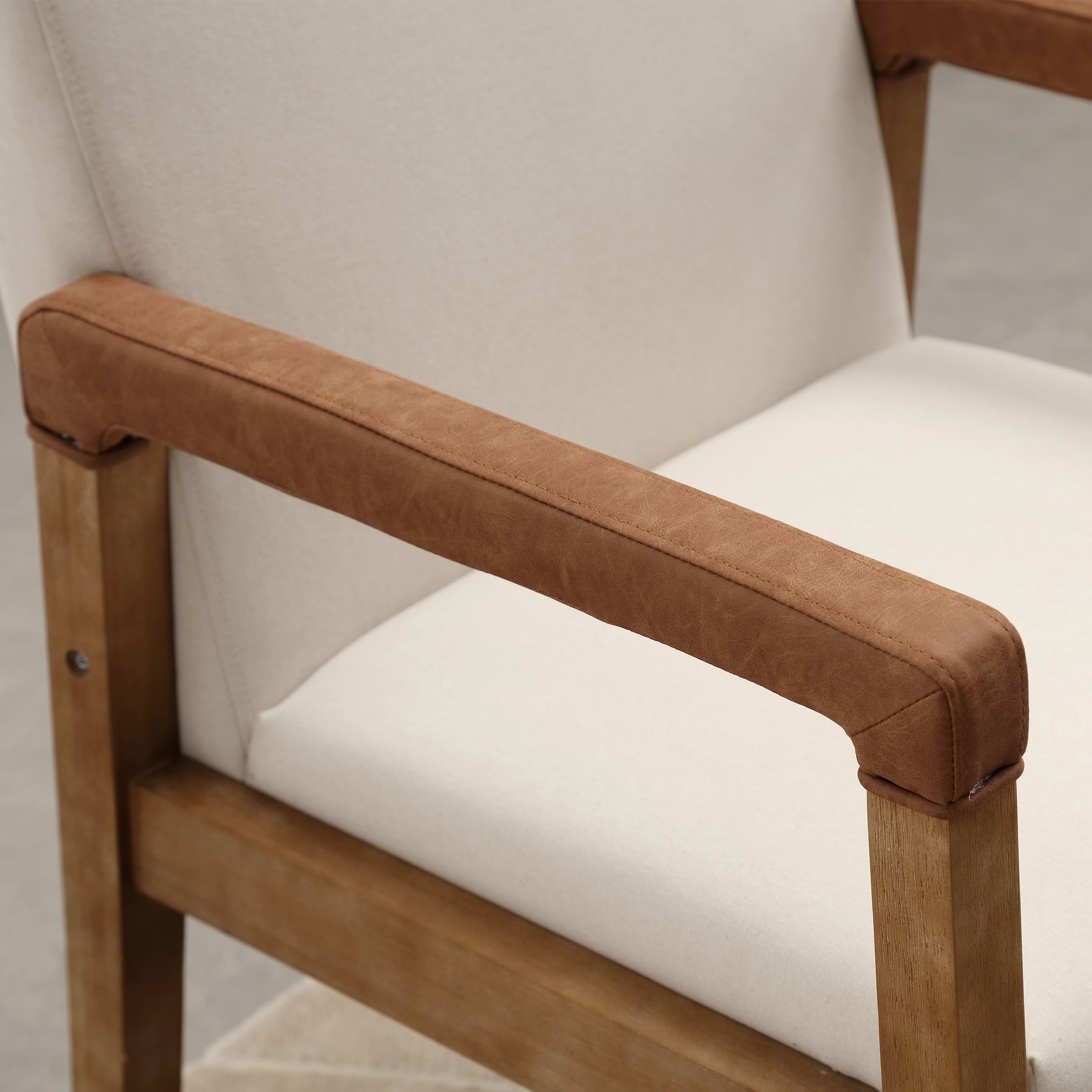 Close-up of leather armrest and wooden leg