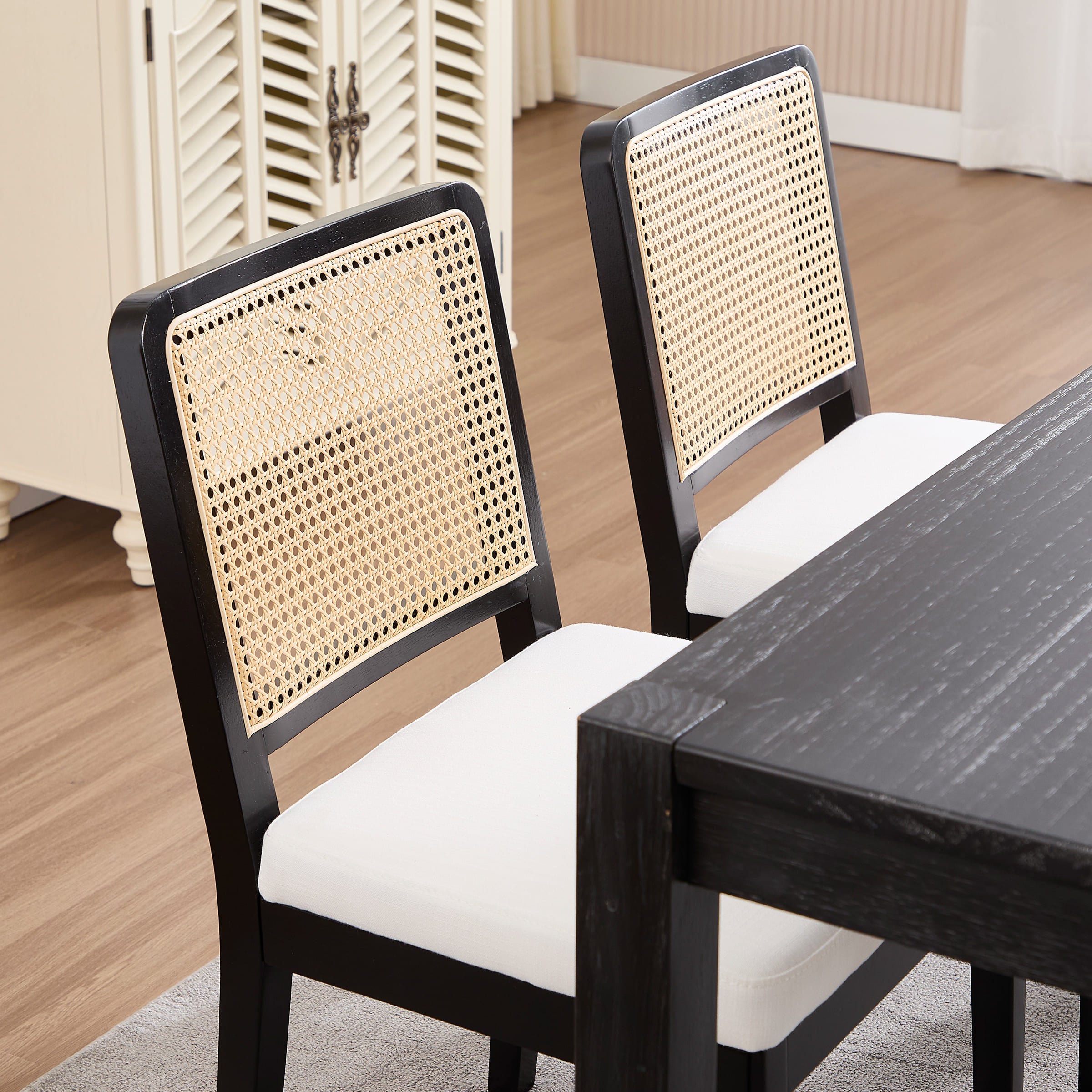 Close-up of chair back with woven cane panel and black frame