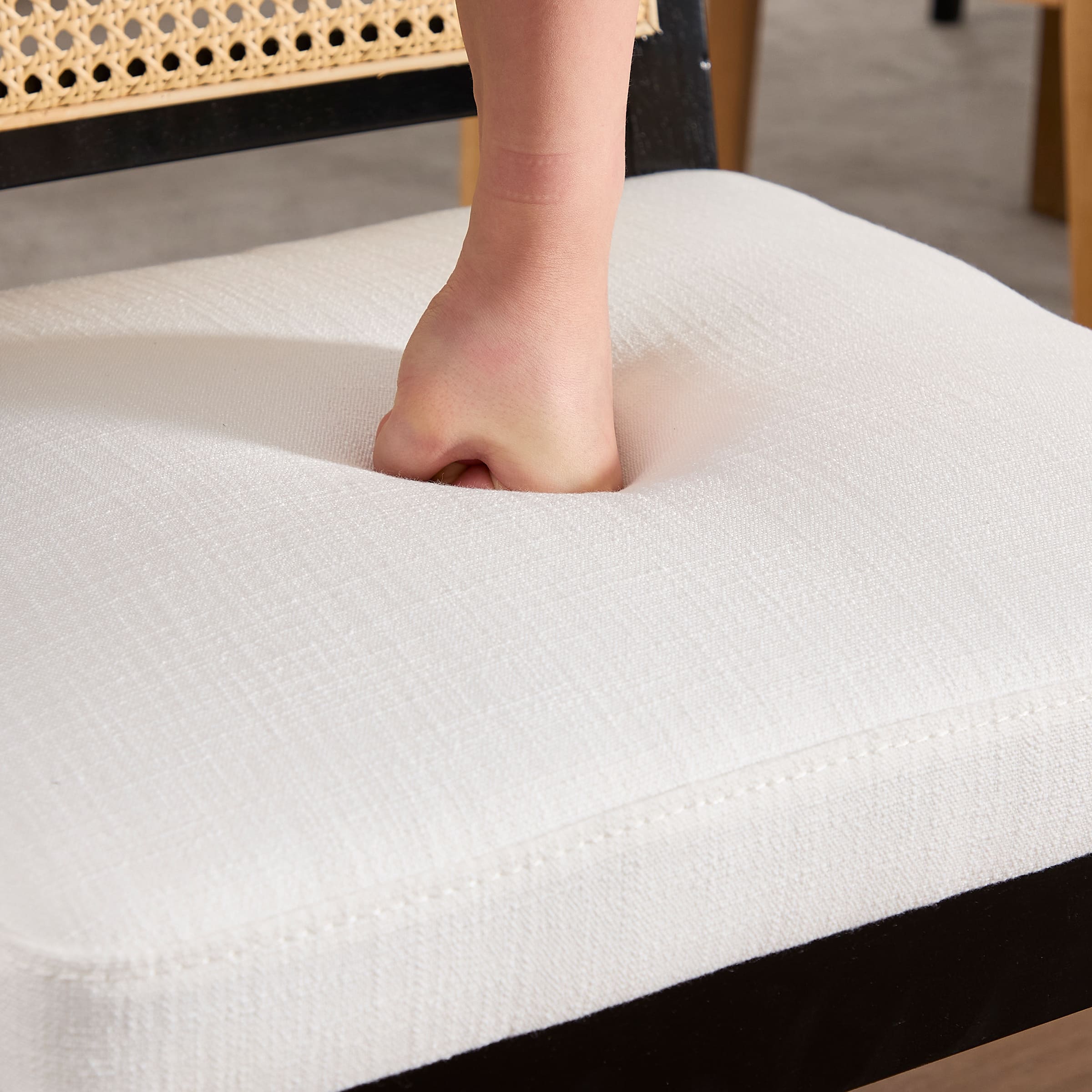 Hand pressing down on chair cushion