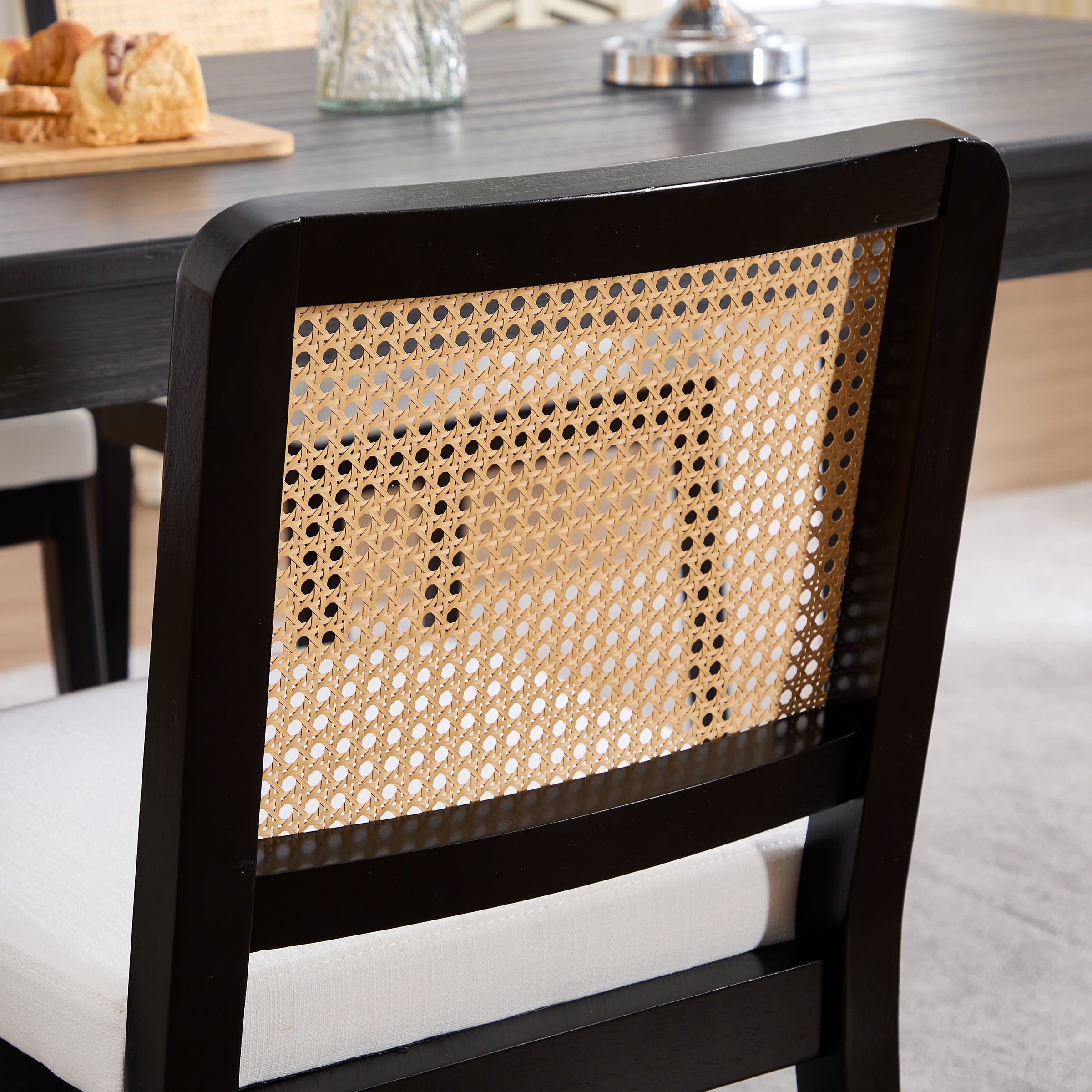 Back of chair with caned panel and reflection