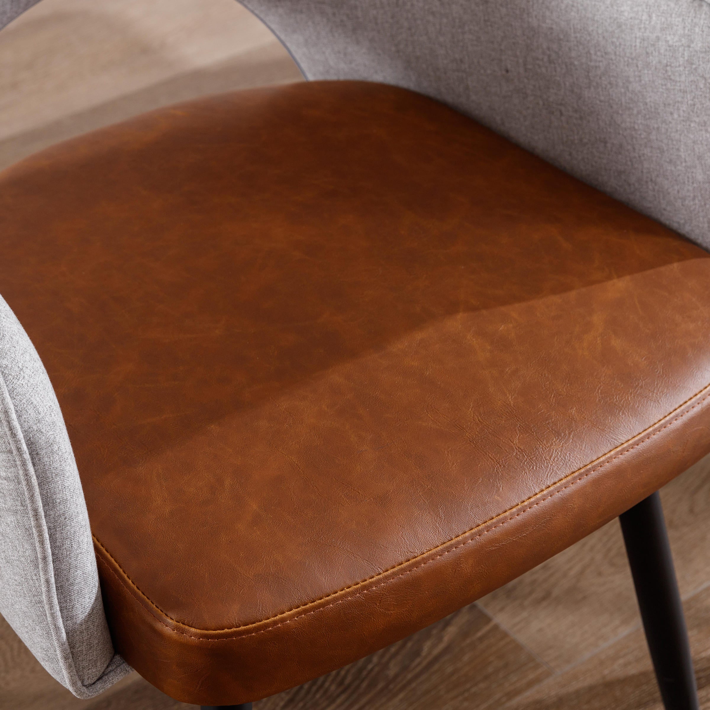 Close-up of brown leather seat cushion on chair