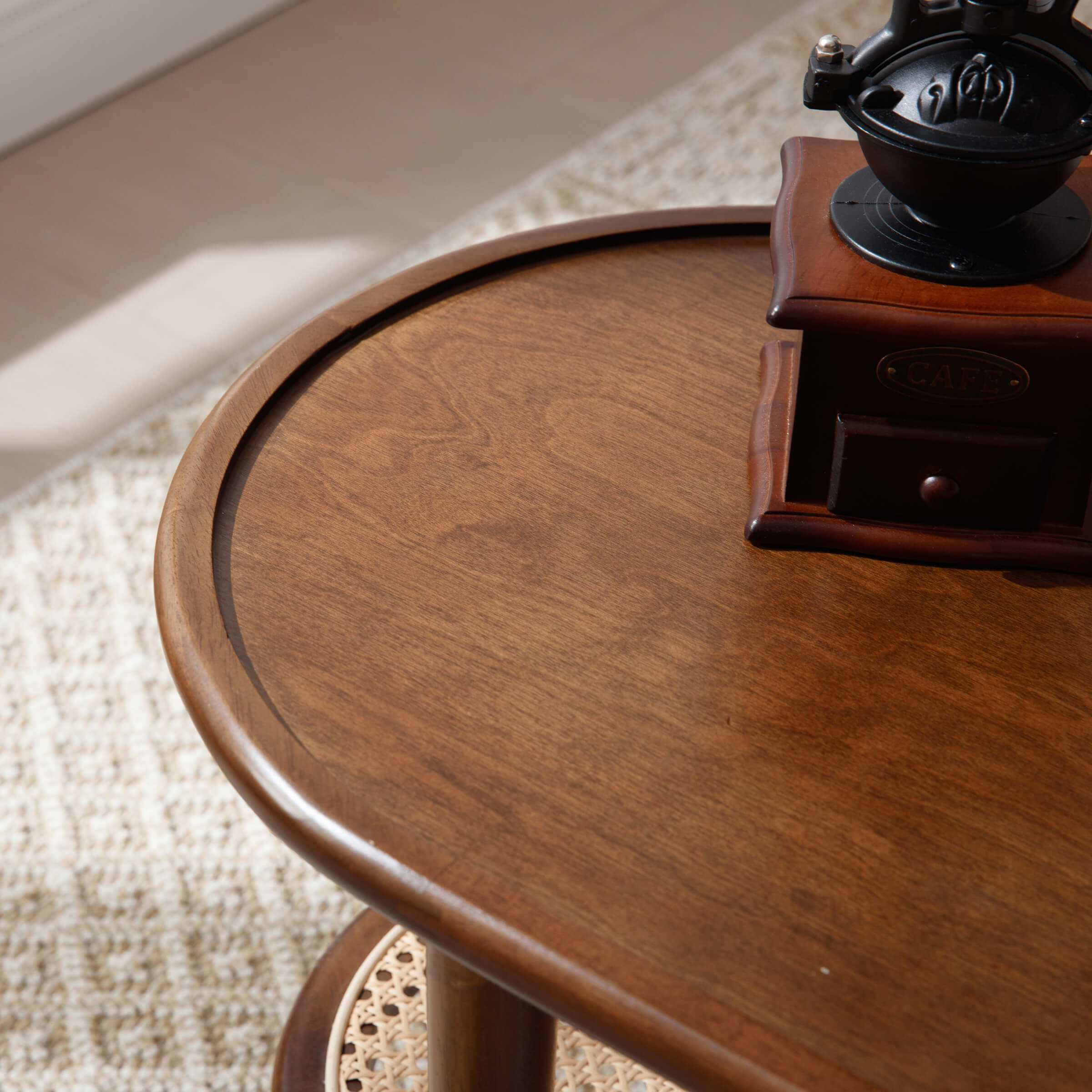 Wooden oval table top close-up showing wood grain and curved edge