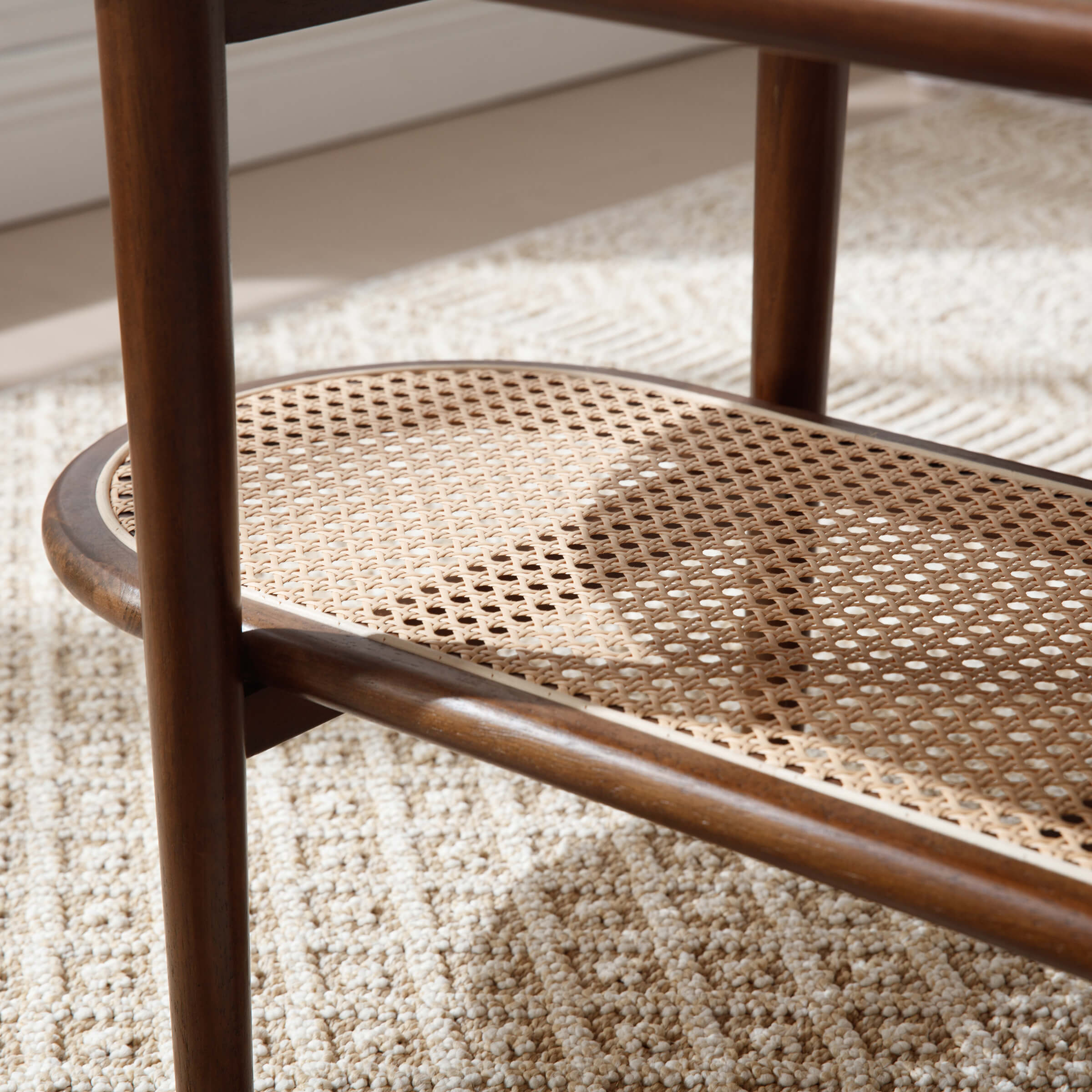 Lower shelf woven cane surface under oval table