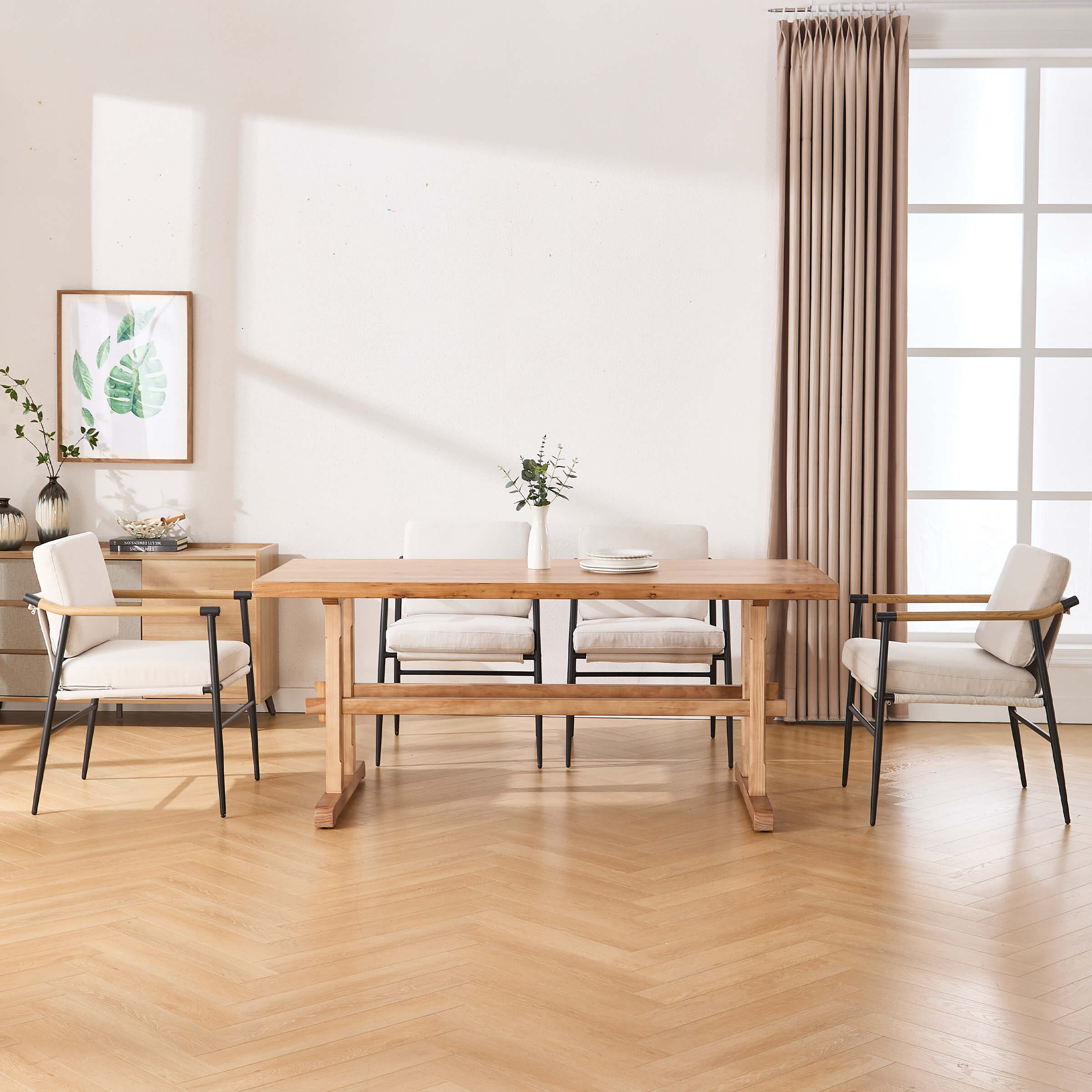 Dining table with four chairs around it in a bright room