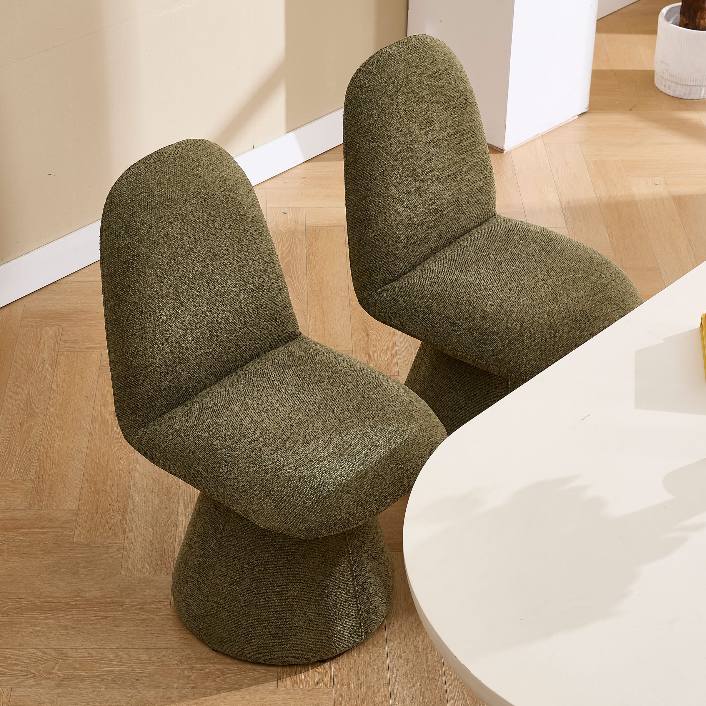 Close-up of olive-green swivel chair seat back and base