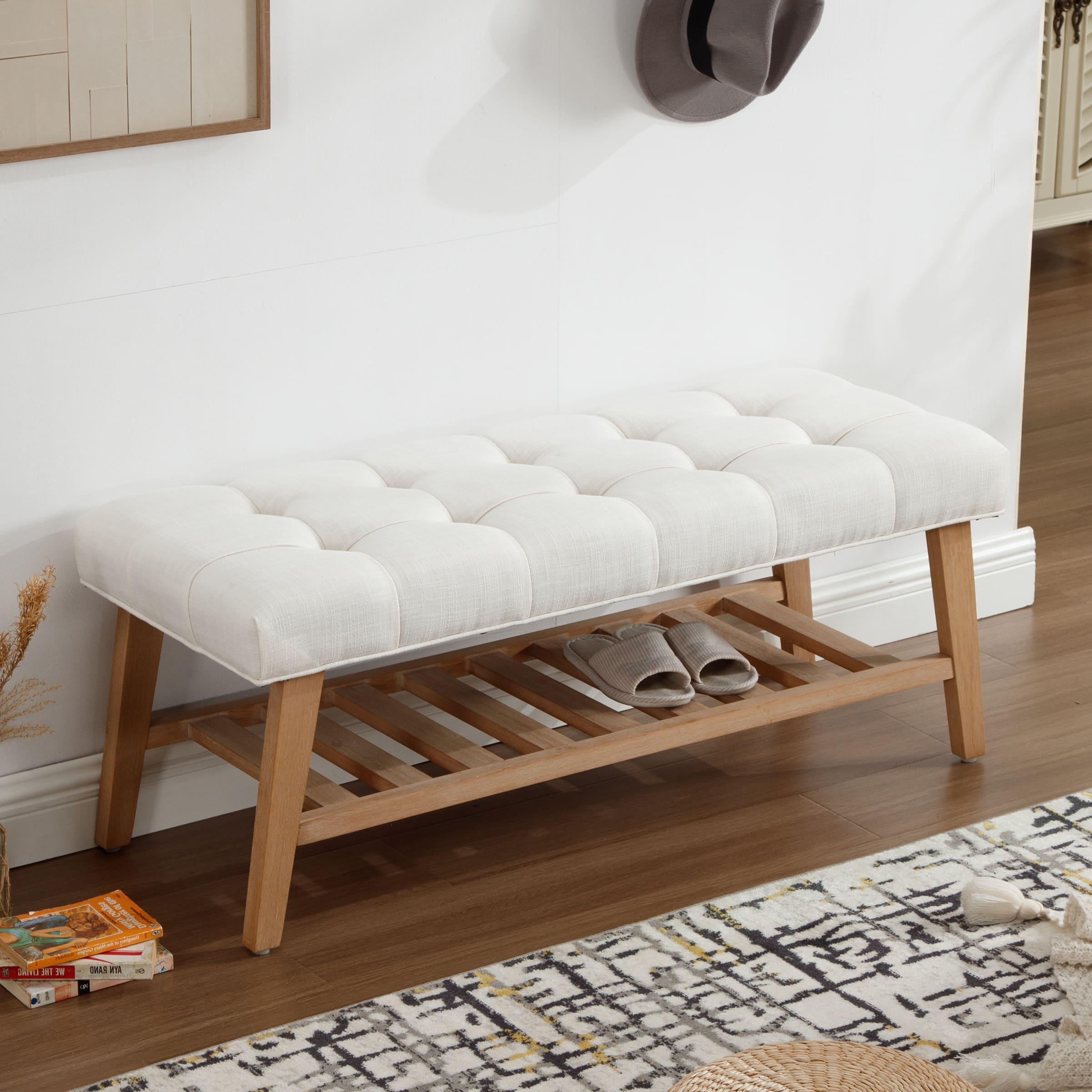 Bench with tufted white cushion in a room