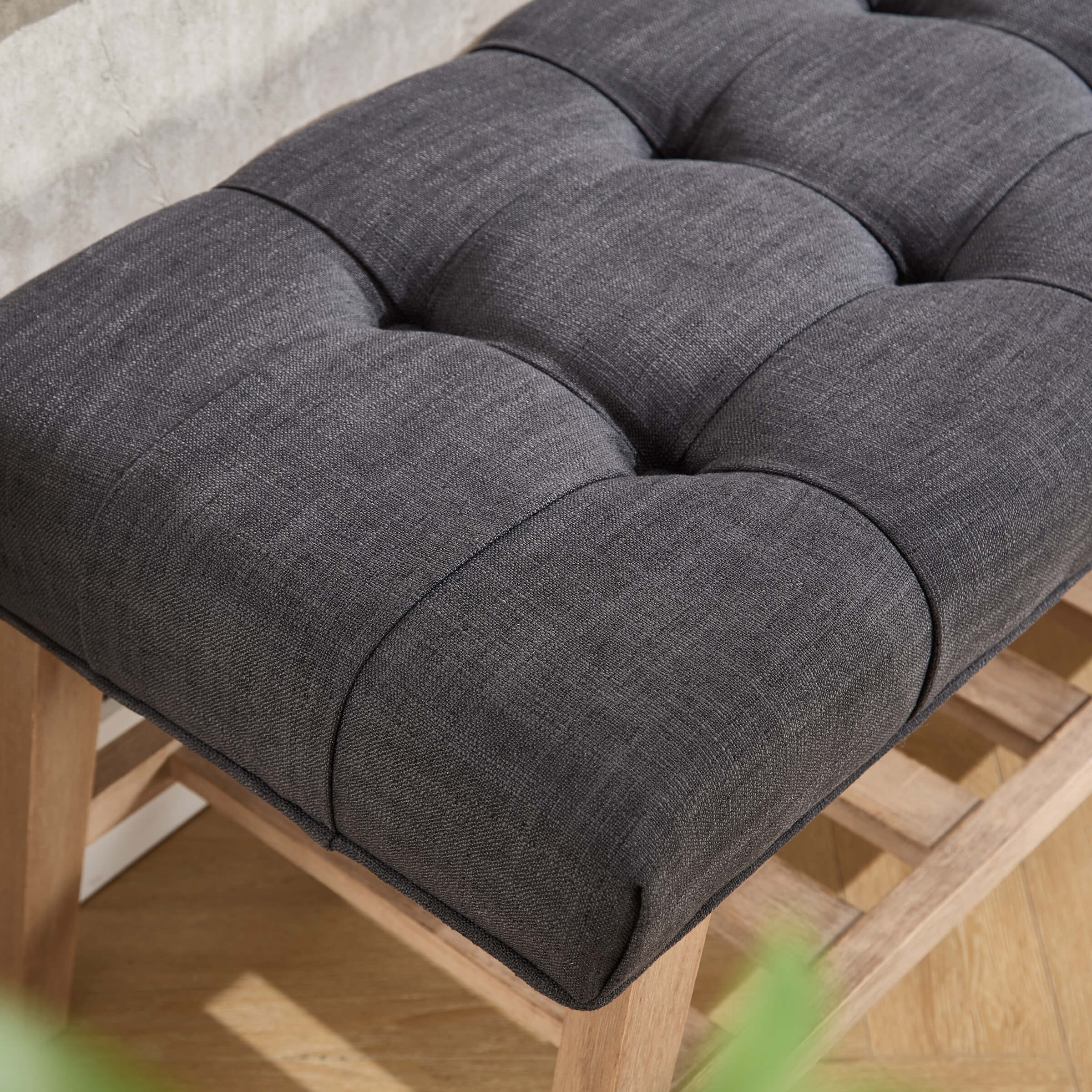 Close-up of tufted cushion texture with stitching