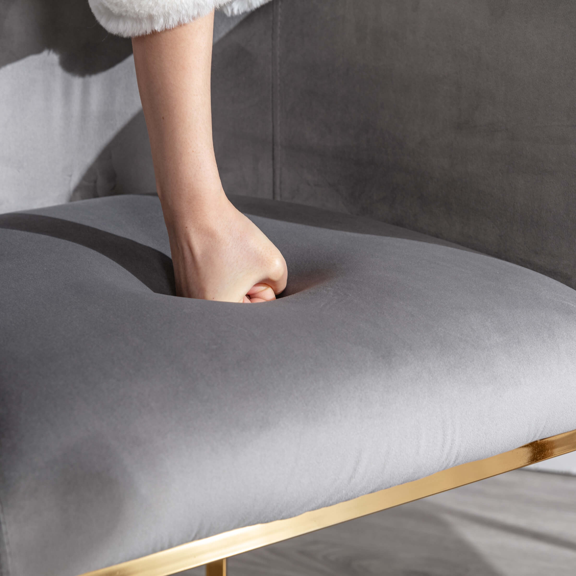 Finger pressing blue upholstery