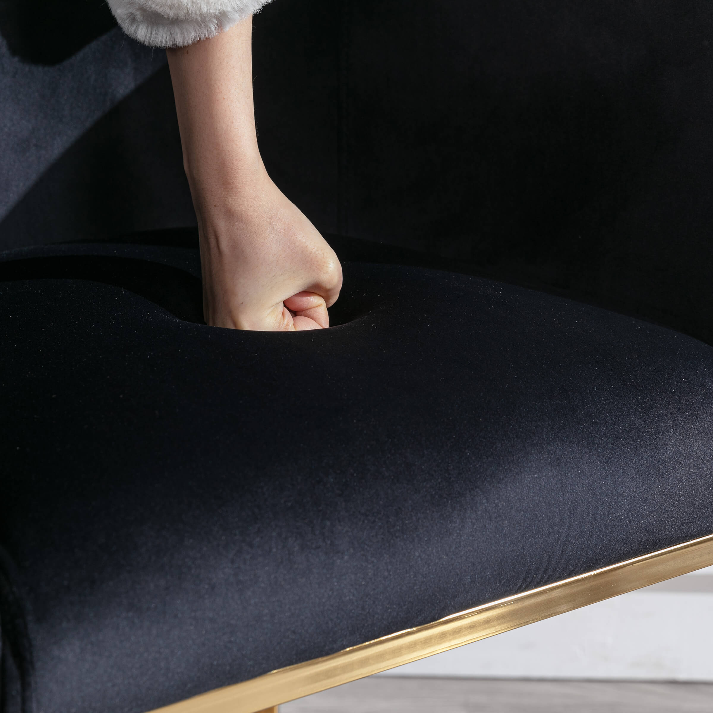 Close-up of dark upholstery being pressed