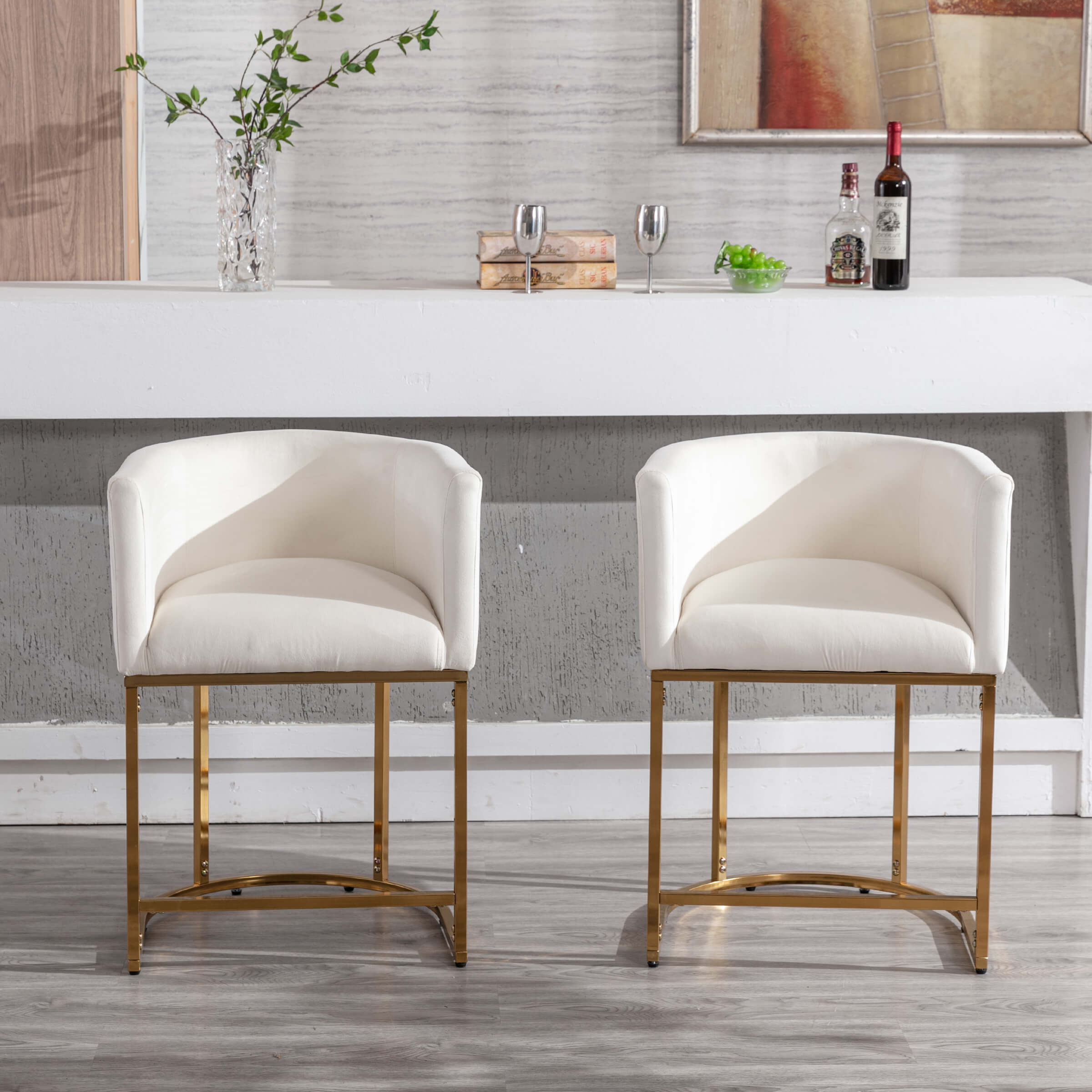 Pair of white upholstered counter stools with gold frames