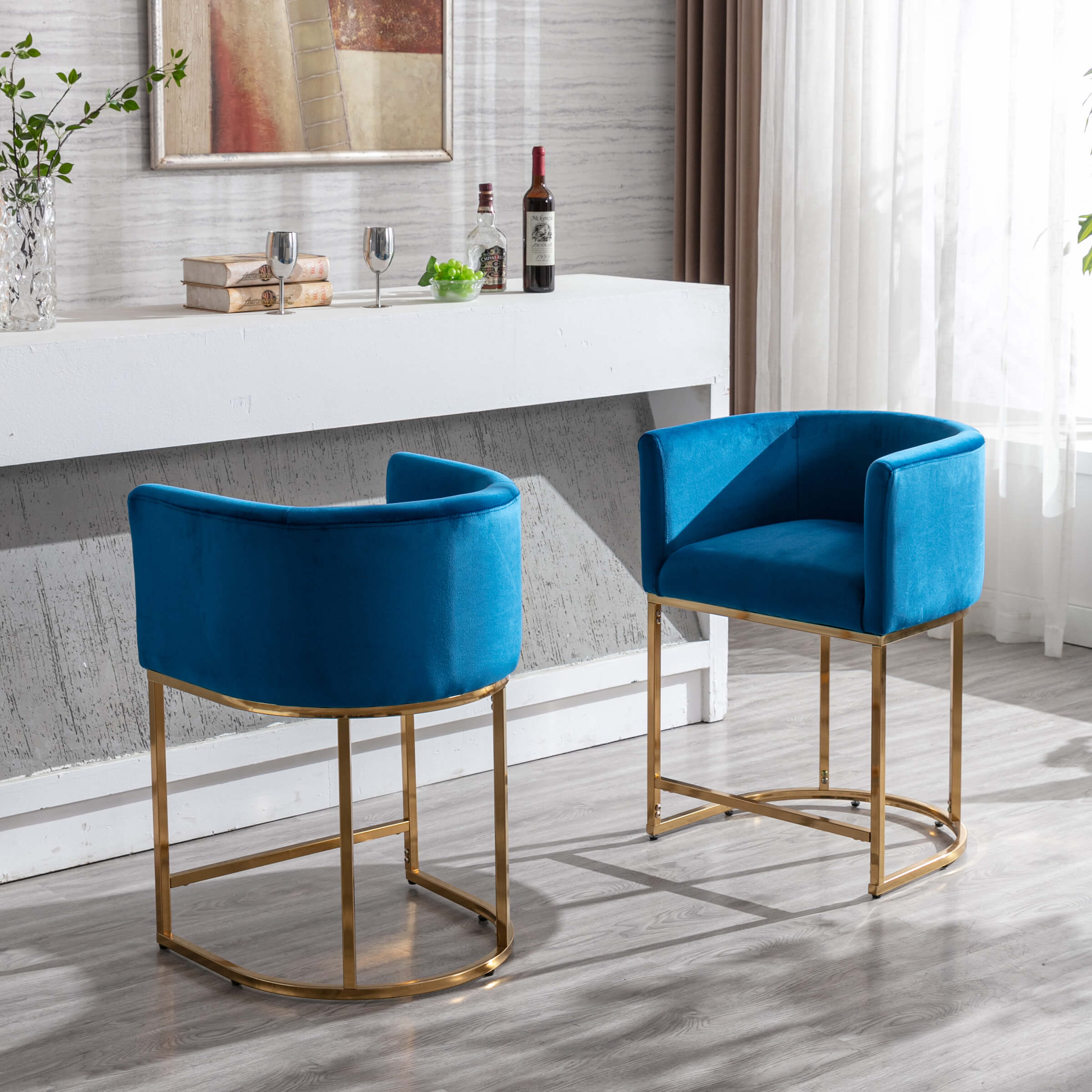 Blue velvet stools at a counter with bottles