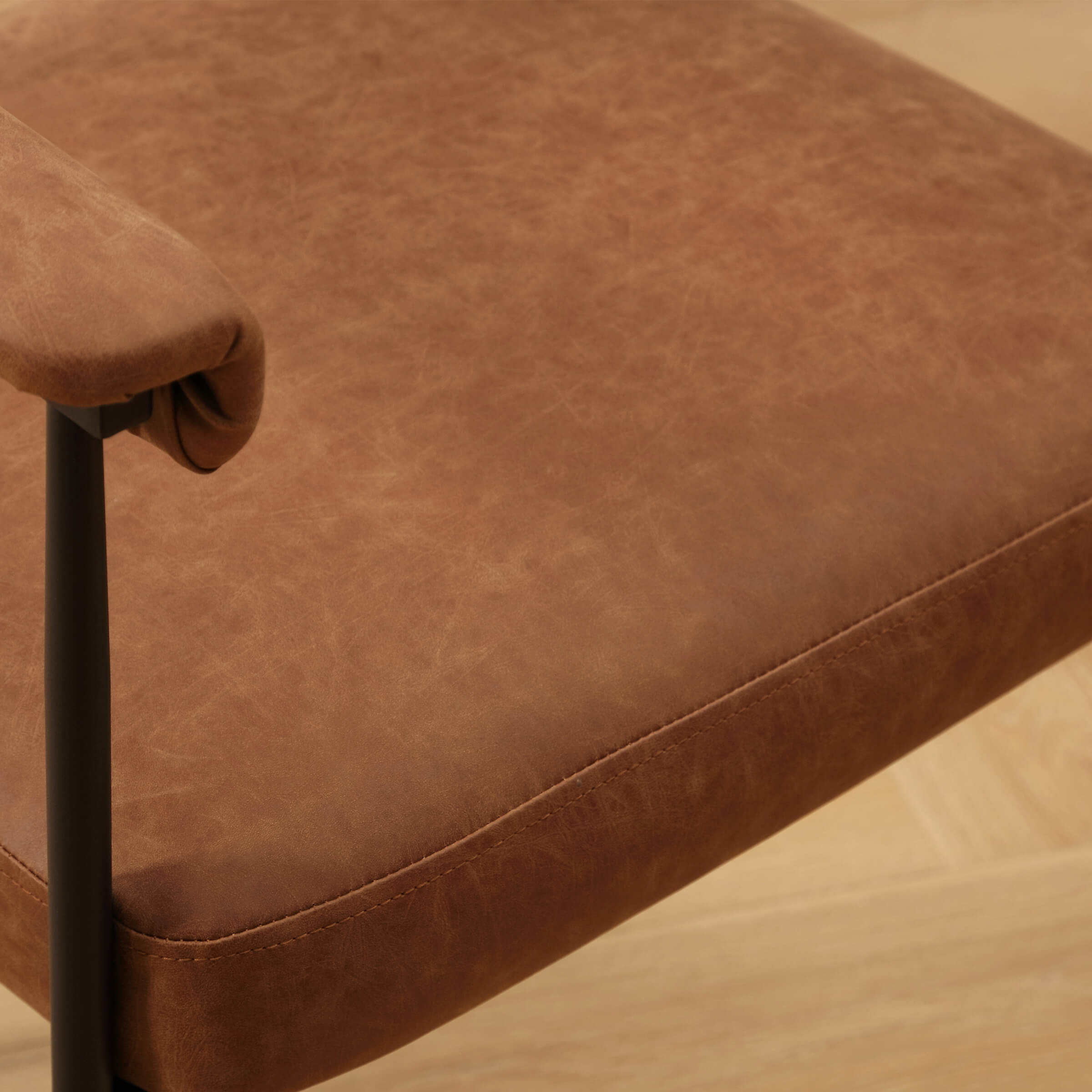 Close-up of brown leather-like seat cushion with texture