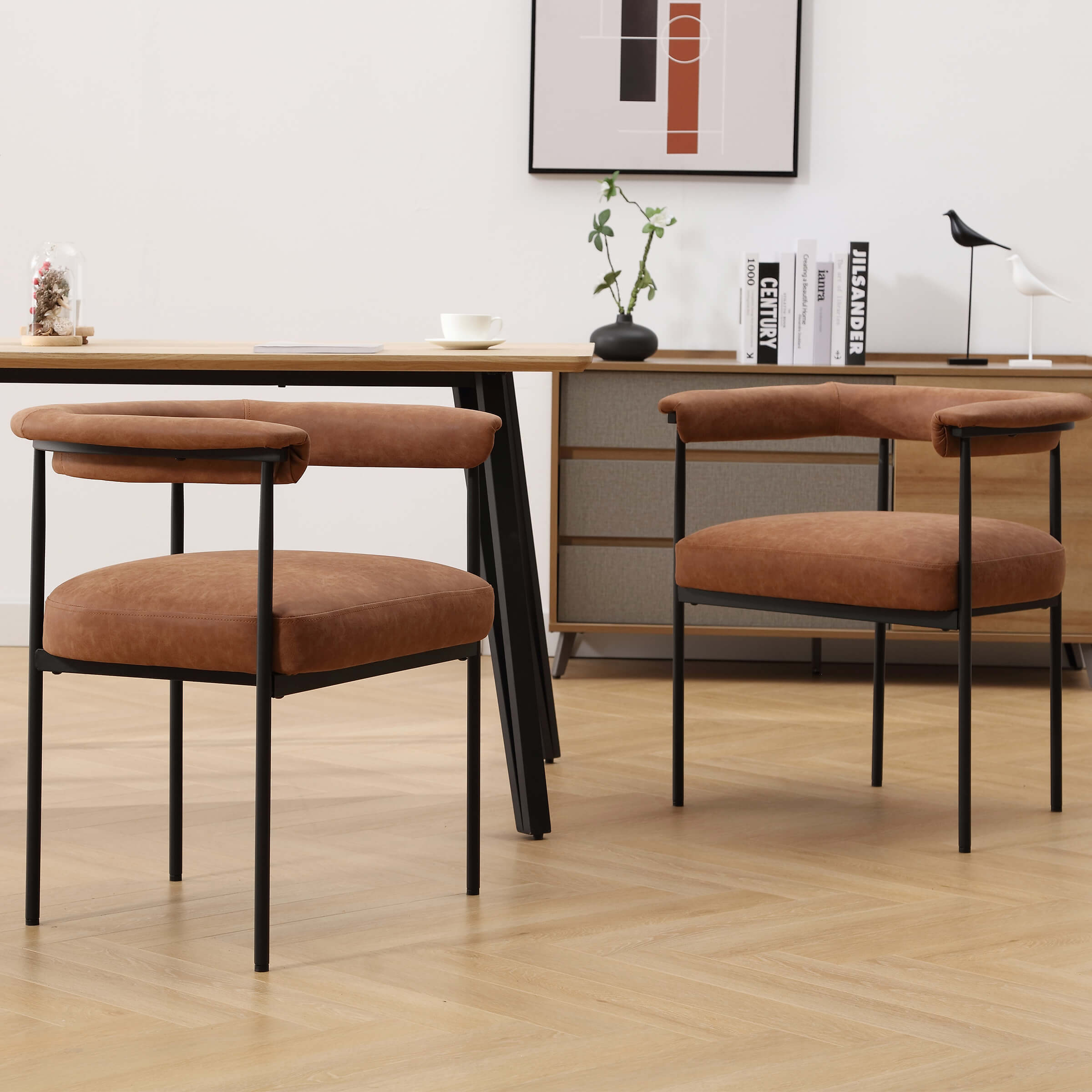 Set of two modern barrel dining chairs in brown upholstery with black legs