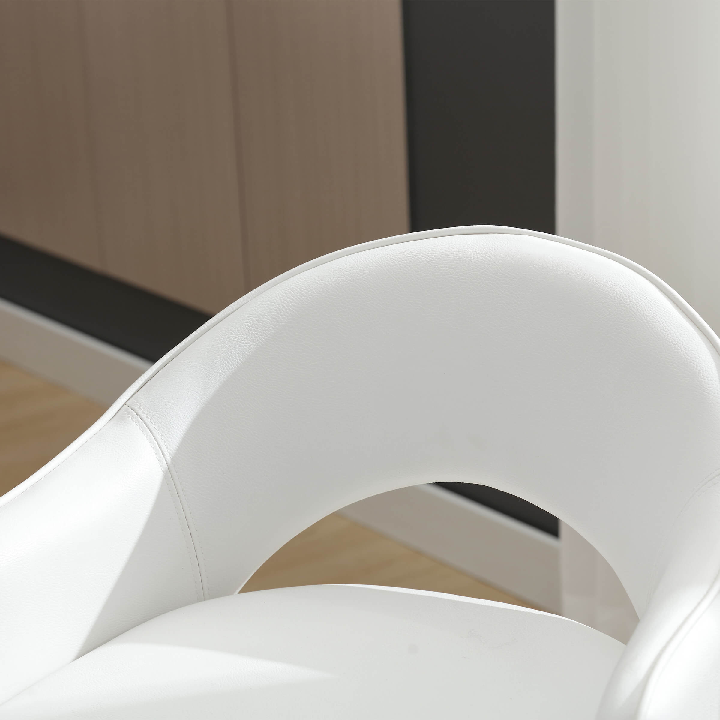 Close-up of white upholstery on stool back