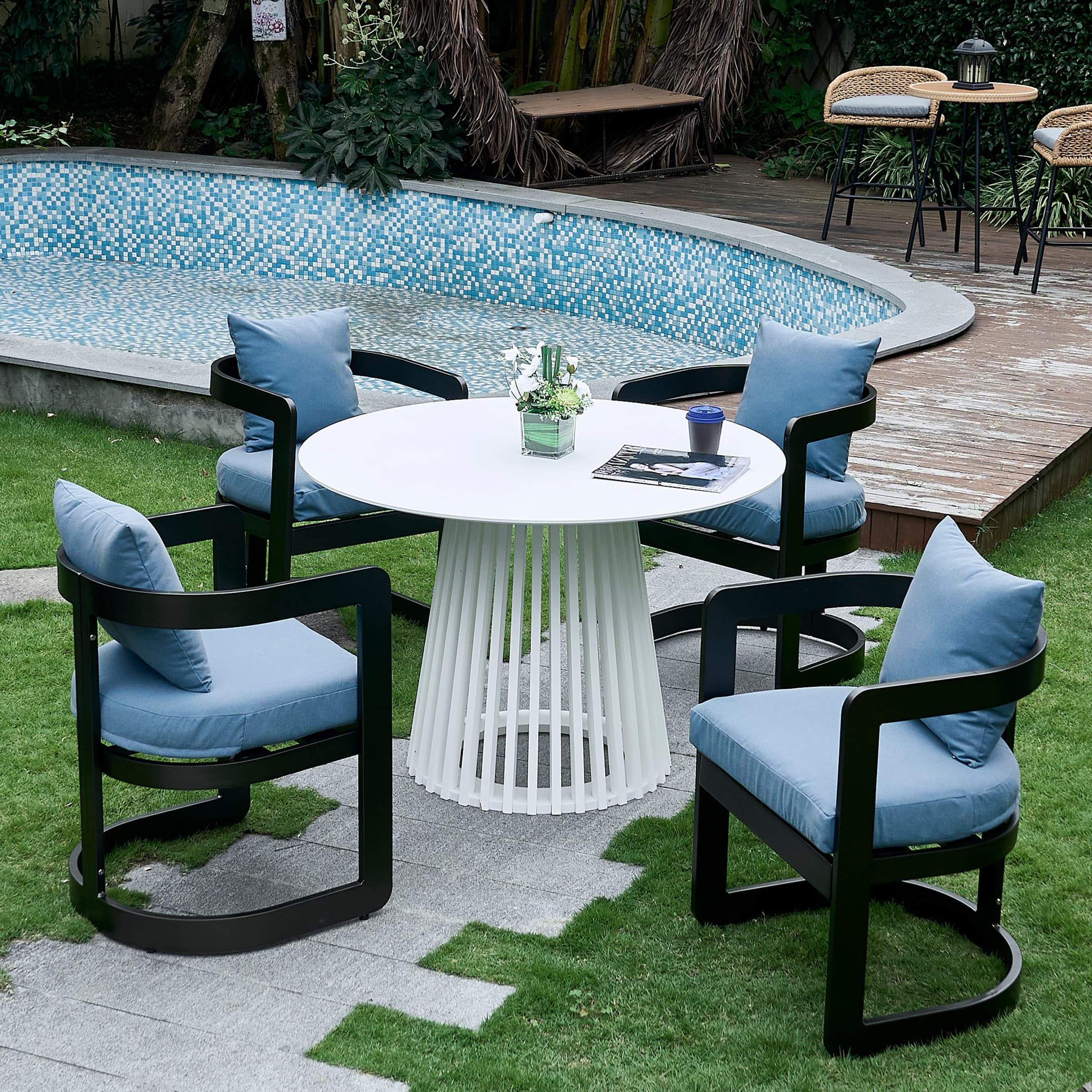 Round table with chairs by pool