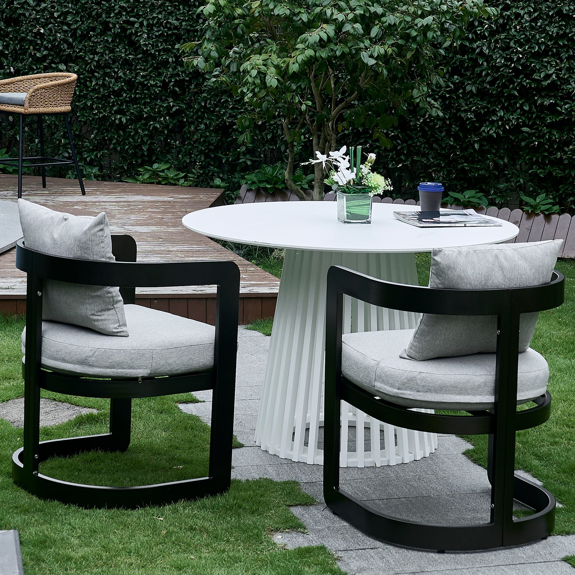 Chairs around white table on grass