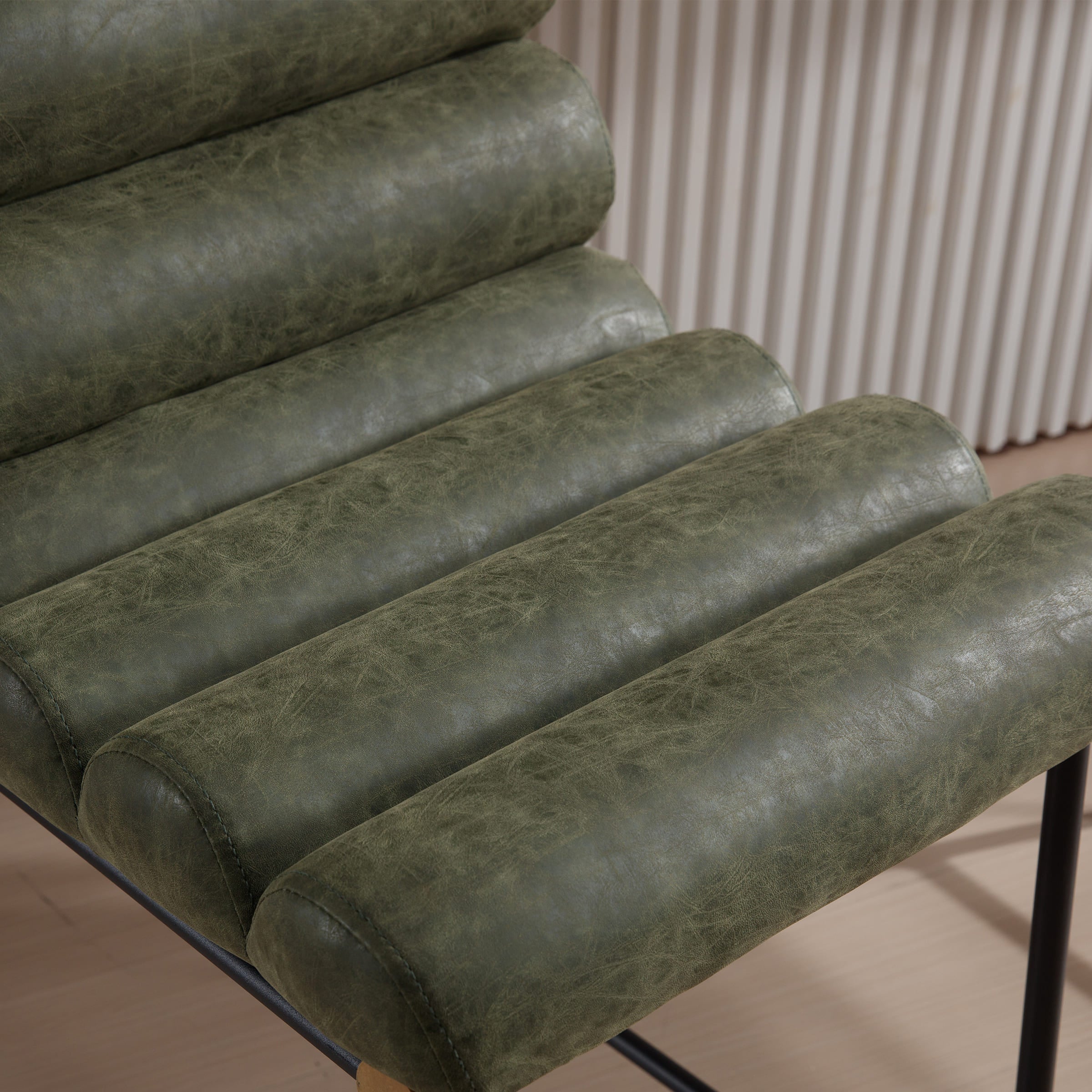 Close-up of green leather-like upholstery on stool