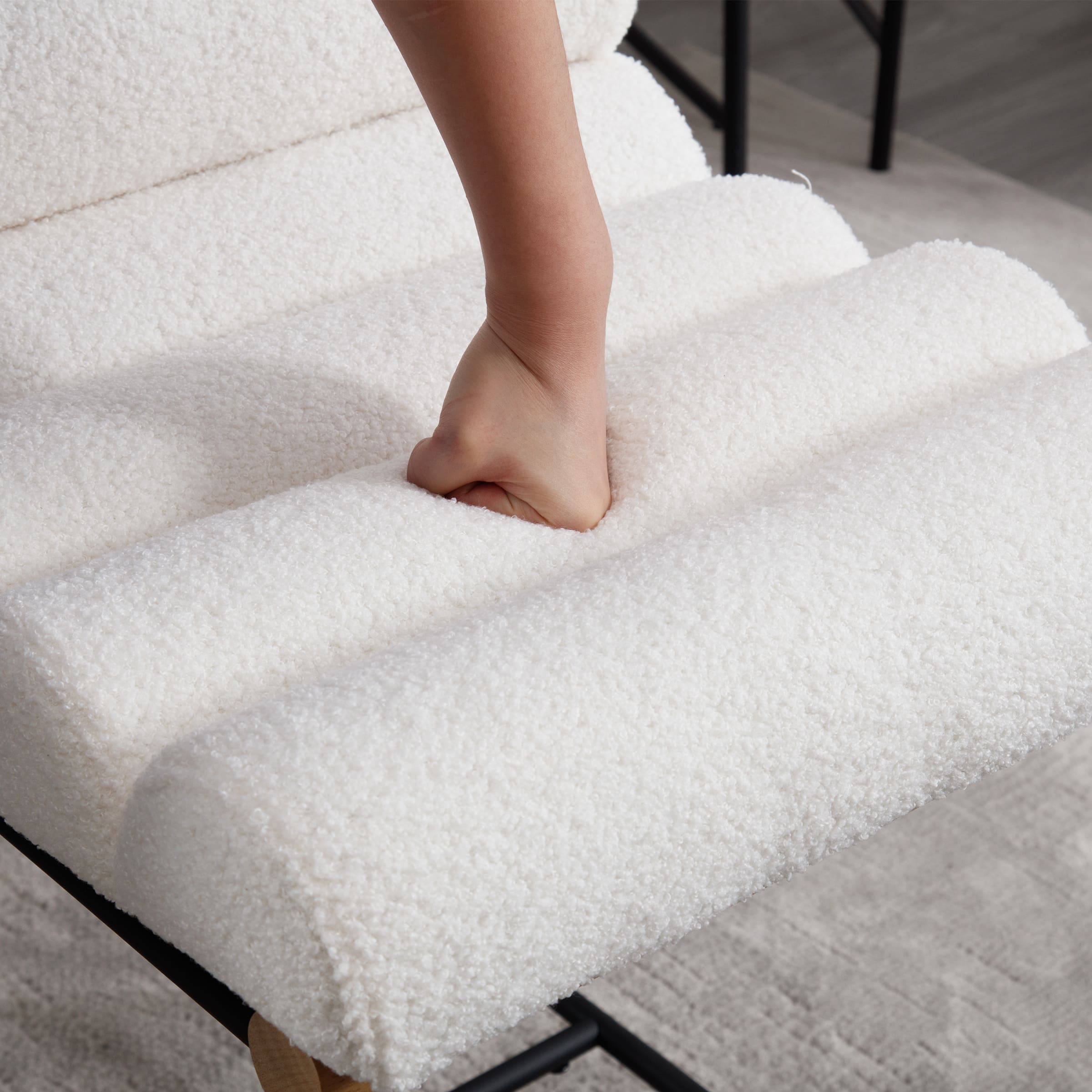 Stools with hand pressing on white upholstery