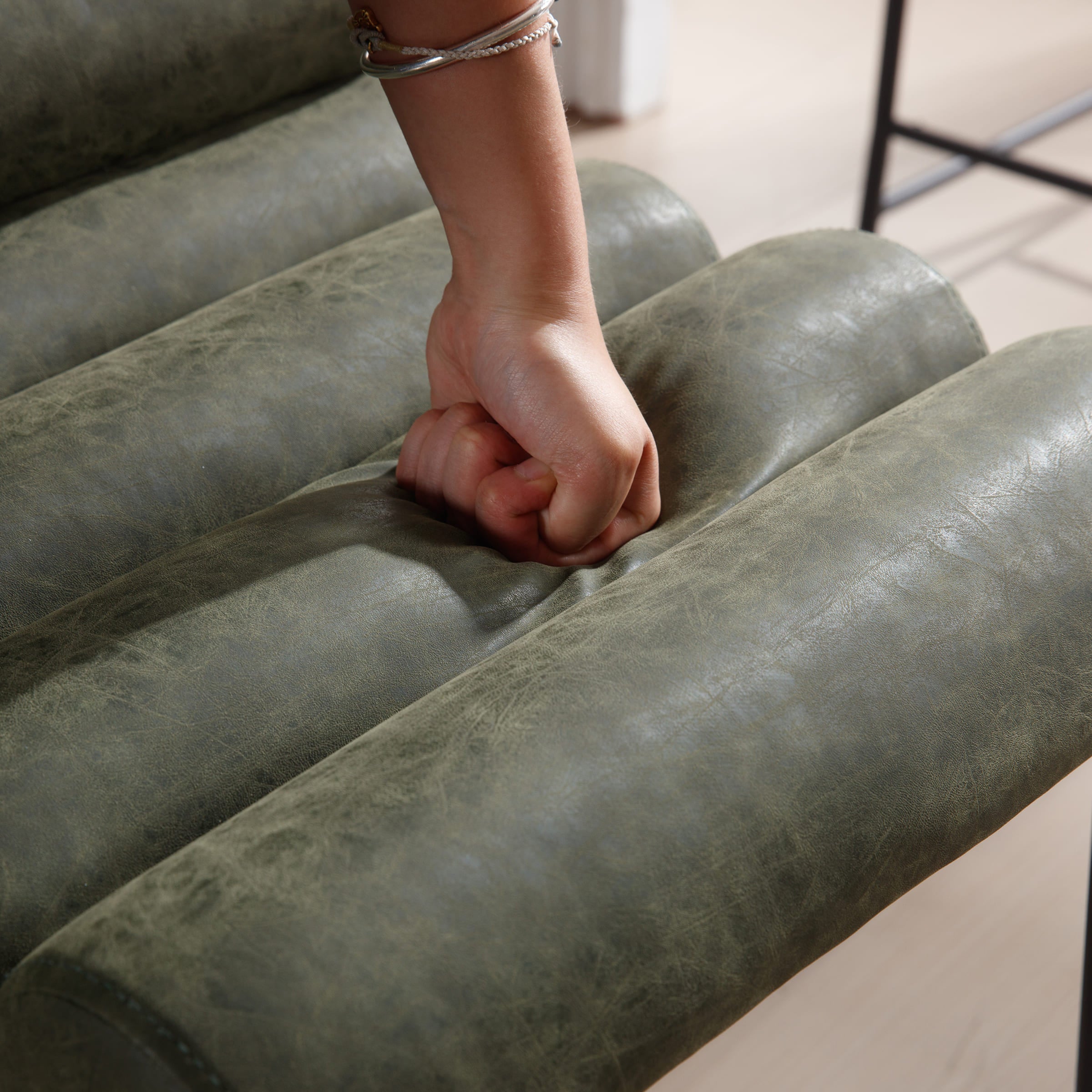 Hand pressing upholstery showing firmness
