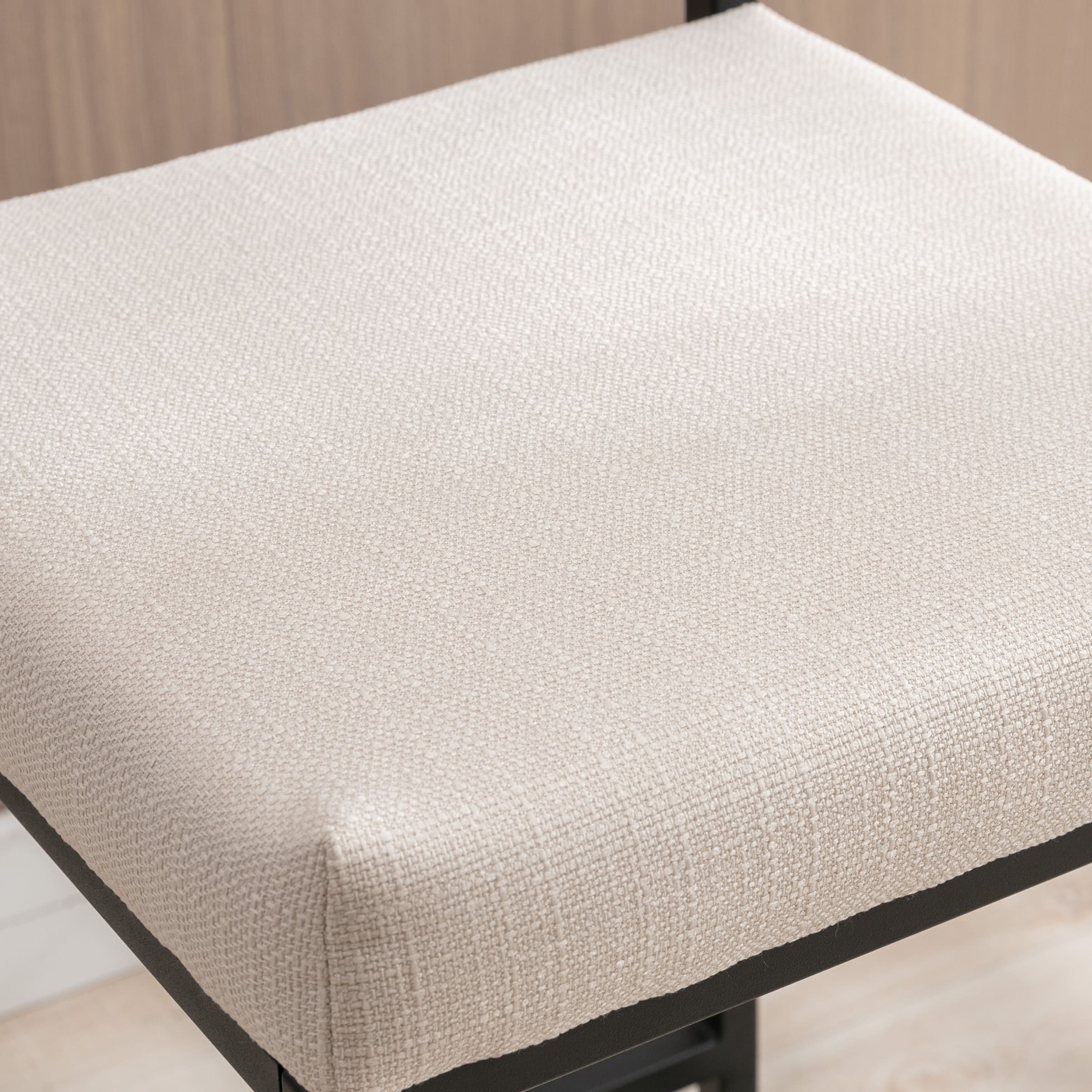 Close-up of beige upholstered seat fabric